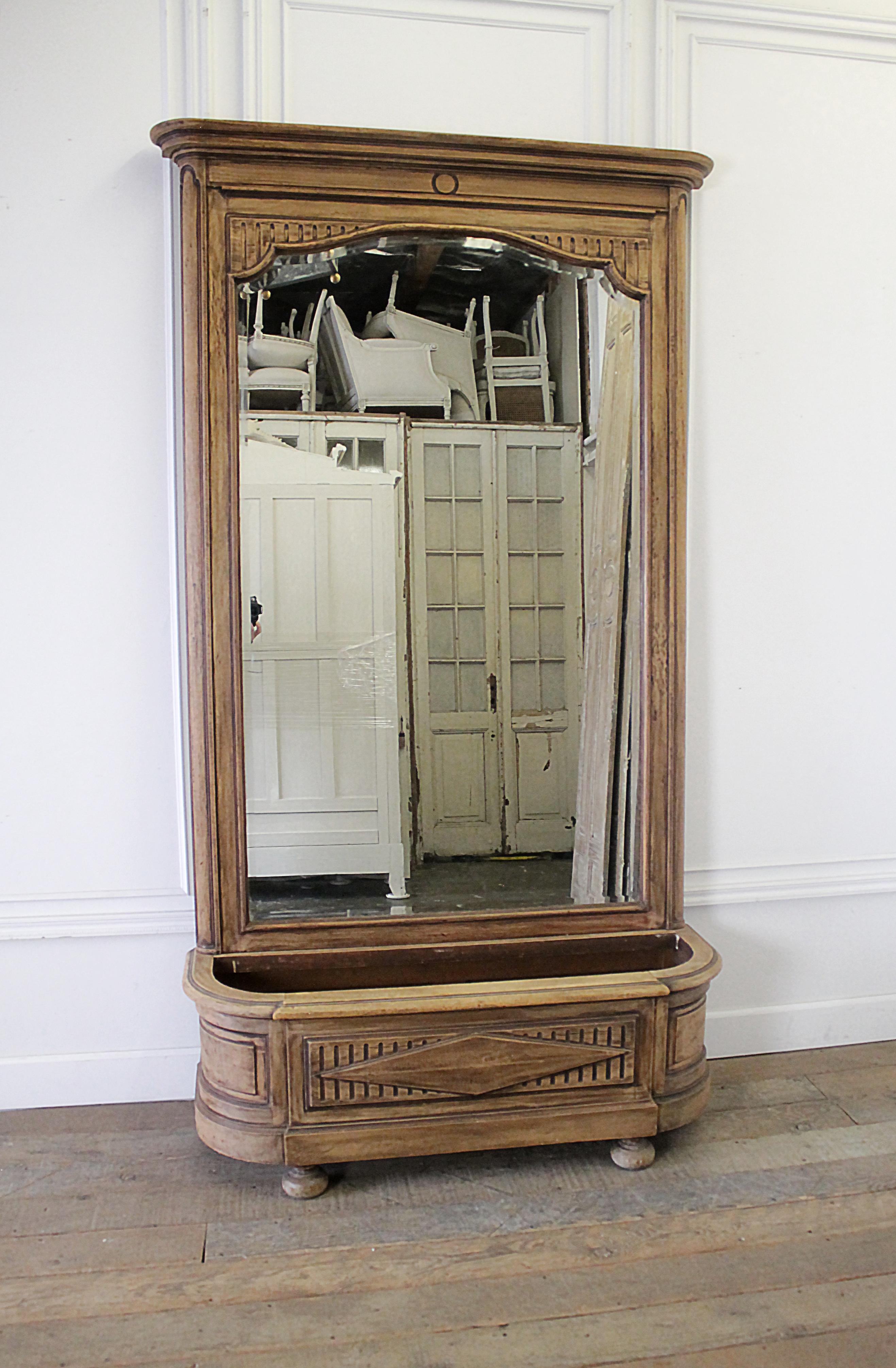 Early 20th century Italian Trumeau mirror with plant stand
A medium walnut color, that has been sanded to show a two-tone finish. 
This is 2 pieces, the mirror separates from the base.
Measures: 17