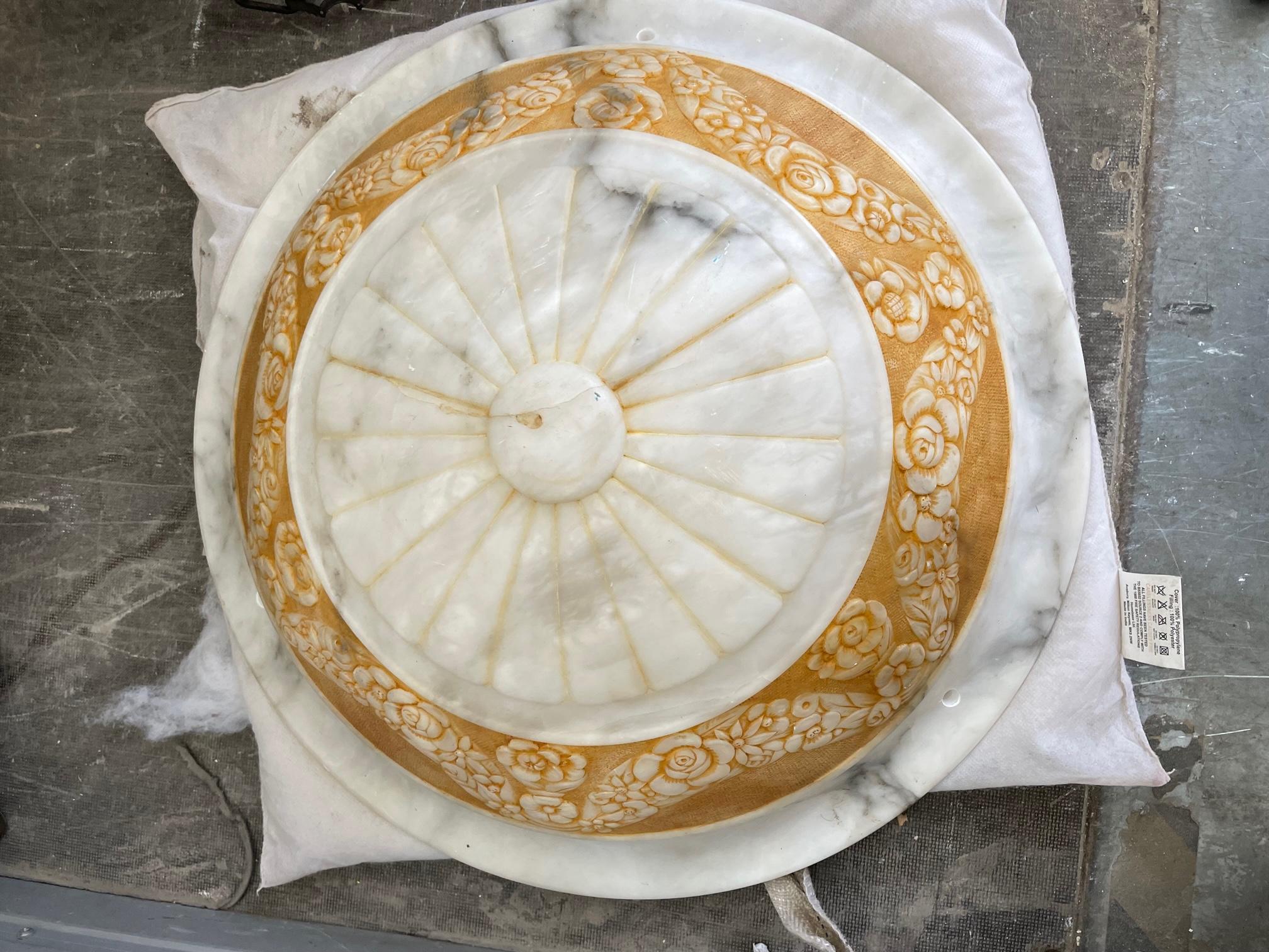 Early 20th century Italian turned and carved alabaster plaffonier of shallow dished form in the Pompeian style, the lobed button centre set within an ochre stained and floral garlanded border, the matching bronzed mental and alabaster ceiling rose