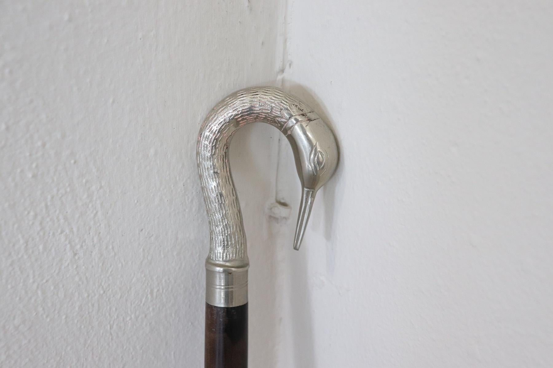 Beautiful walking stick made of precious walnut wood with a finely chiseled silver plated metal handle. The handle has a particular swan-head shape. Very elegant for your day and evening walks.