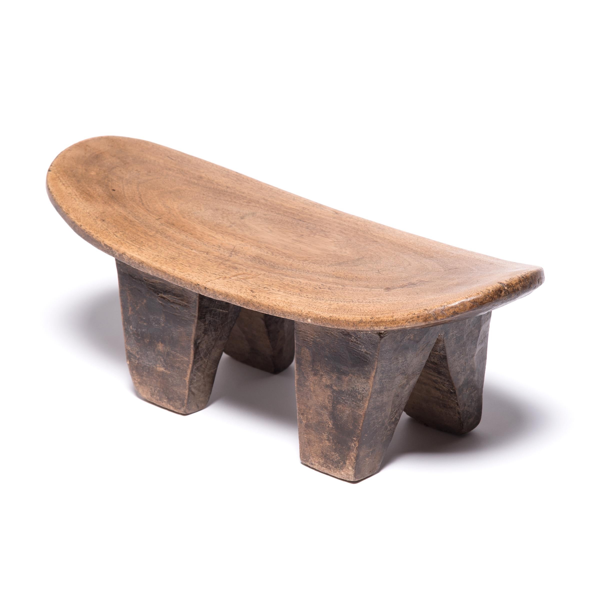 Hand-carved from a single, solid block of wood, each Senufo stool has a unique personality as a modern sculpture, seat, or table. The irregular strokes and diminutive nature are telltale signs of this traditional woodcarving practice. Note the