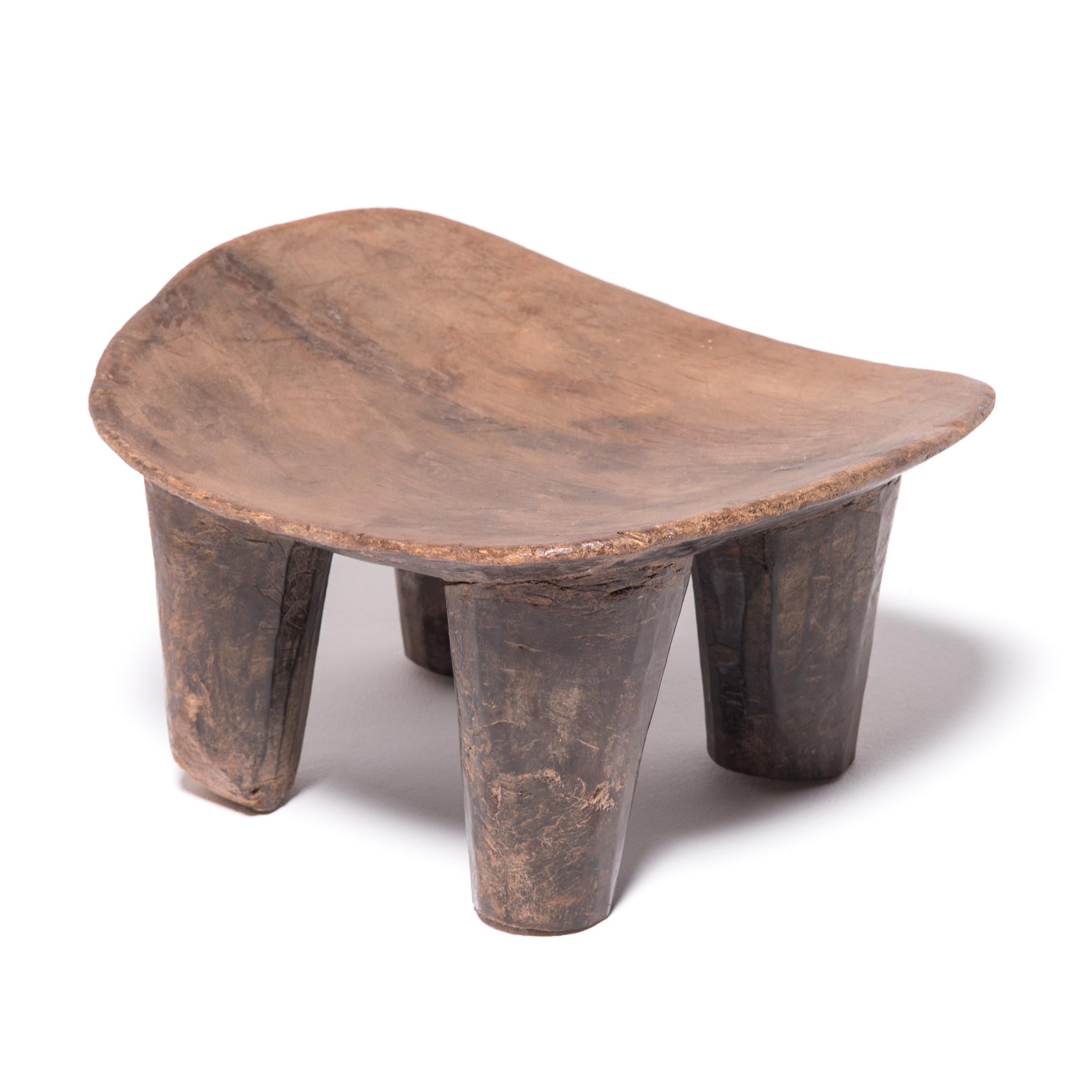 Hand-carved from a single, solid block of wood, each Senufo stool retains a unique personality as a modern sculpture, seat, or table. The irregular strokes and diminutive nature are telltale signs of this traditional woodcarving practice. The