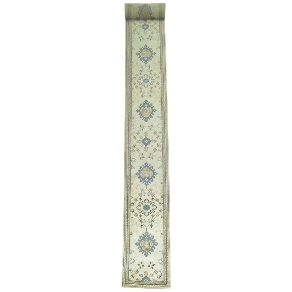 Early 20th Century Ivory Field Long Antique Turkish Oushak Runner For Sale