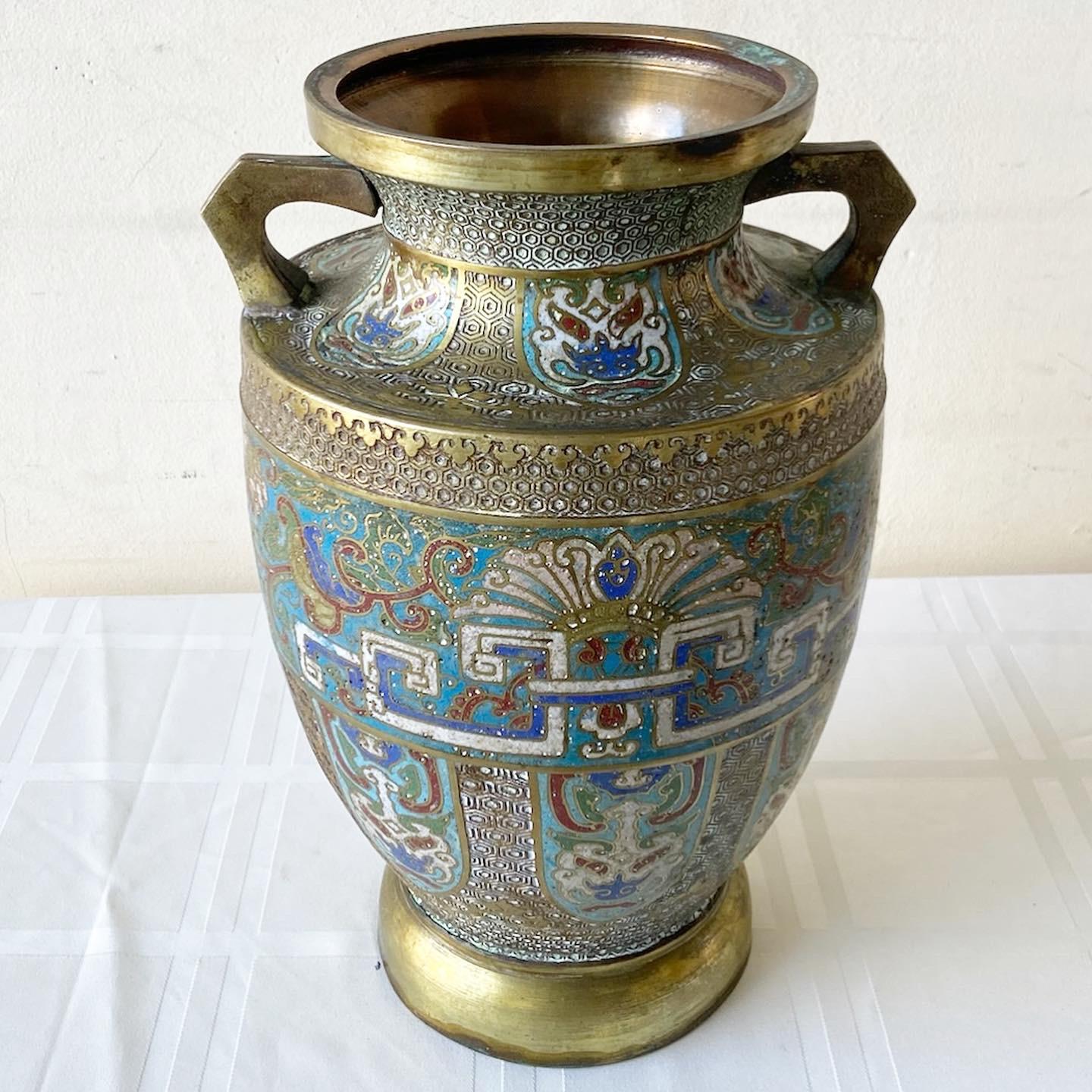 Exceptional vintage early 20th century champleve brass vase. Features a vibrant enamel design throughout the vase.
 