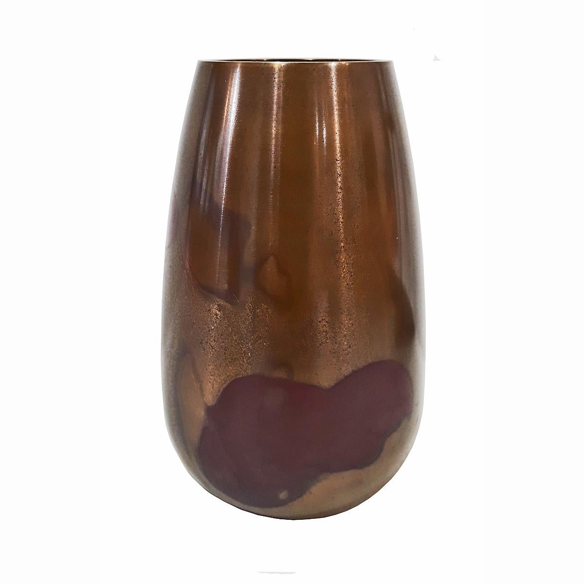 A small polished bronze vase for Ikebana, circa 1925. Japan, Showa period. 

Its simple lines reflect Japanese design. The finishing is Murashido red-oil technique, a centuries-old method by which the vase is dipped in hot oil to give it a