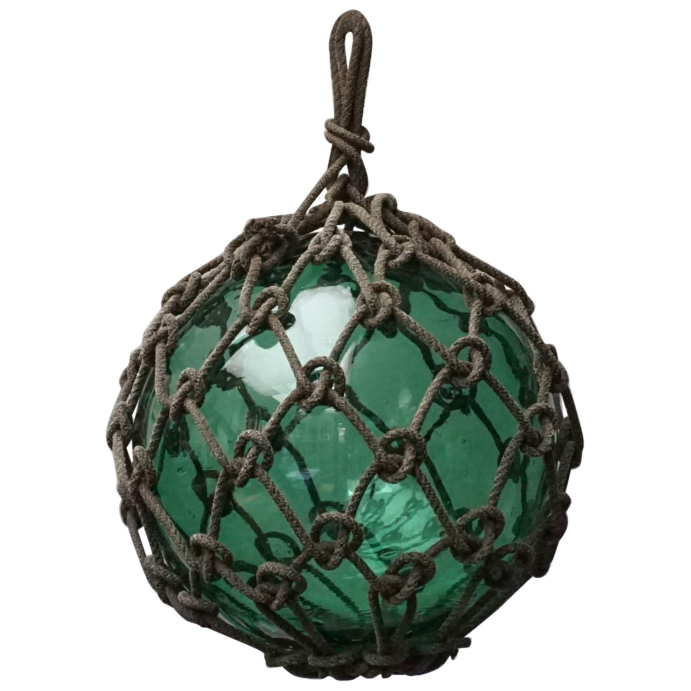 Early 20th Century Japanese Green Glass Fishing Float in Tied Knotted Ropes