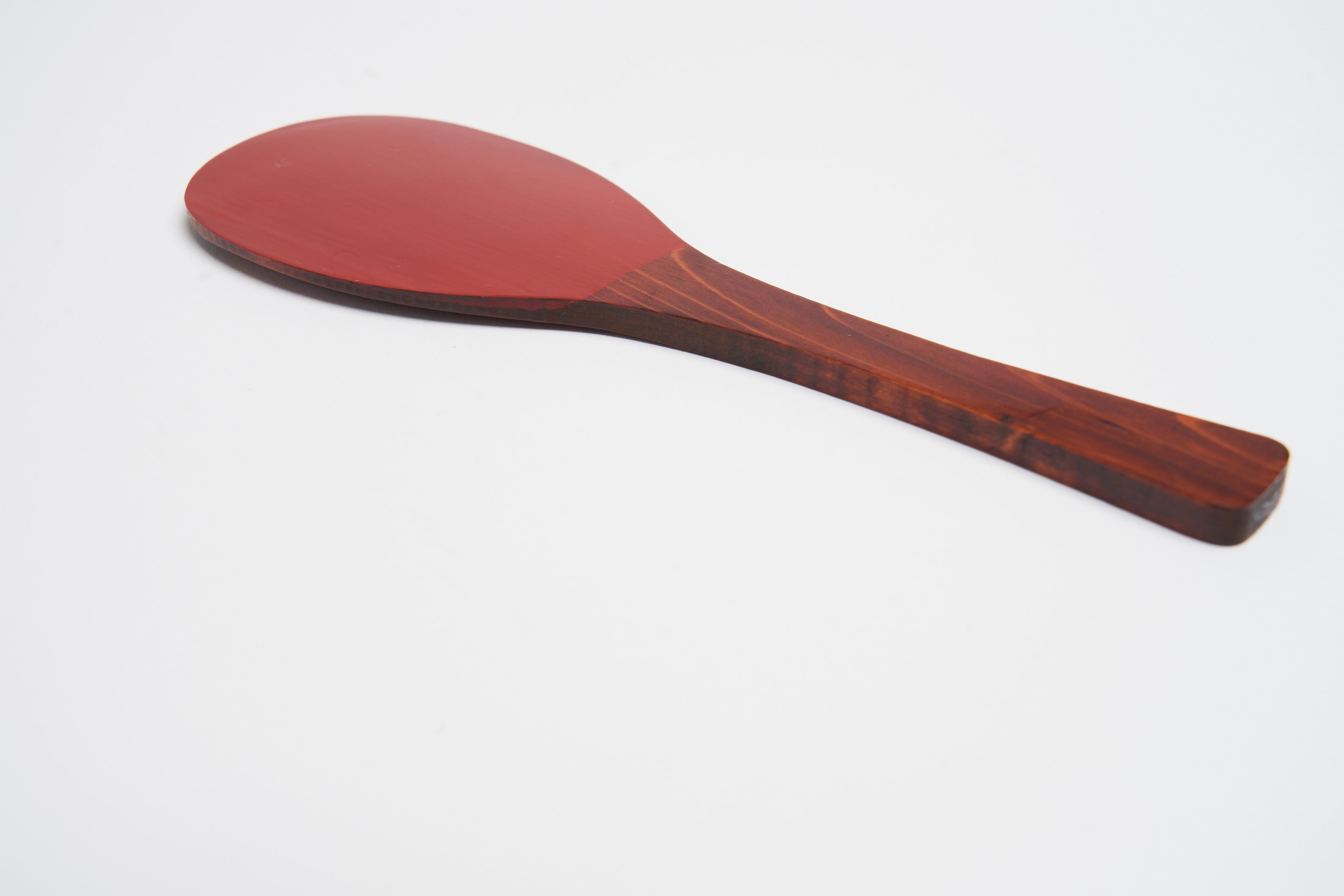 This incredibly beautiful and functional red lacquered hardwood spoon is truly one of a kind. The deep matte like finish of the red lacquer over the wood make this something worth owning. 

The details in the wood, as you can see - sharp angles that
