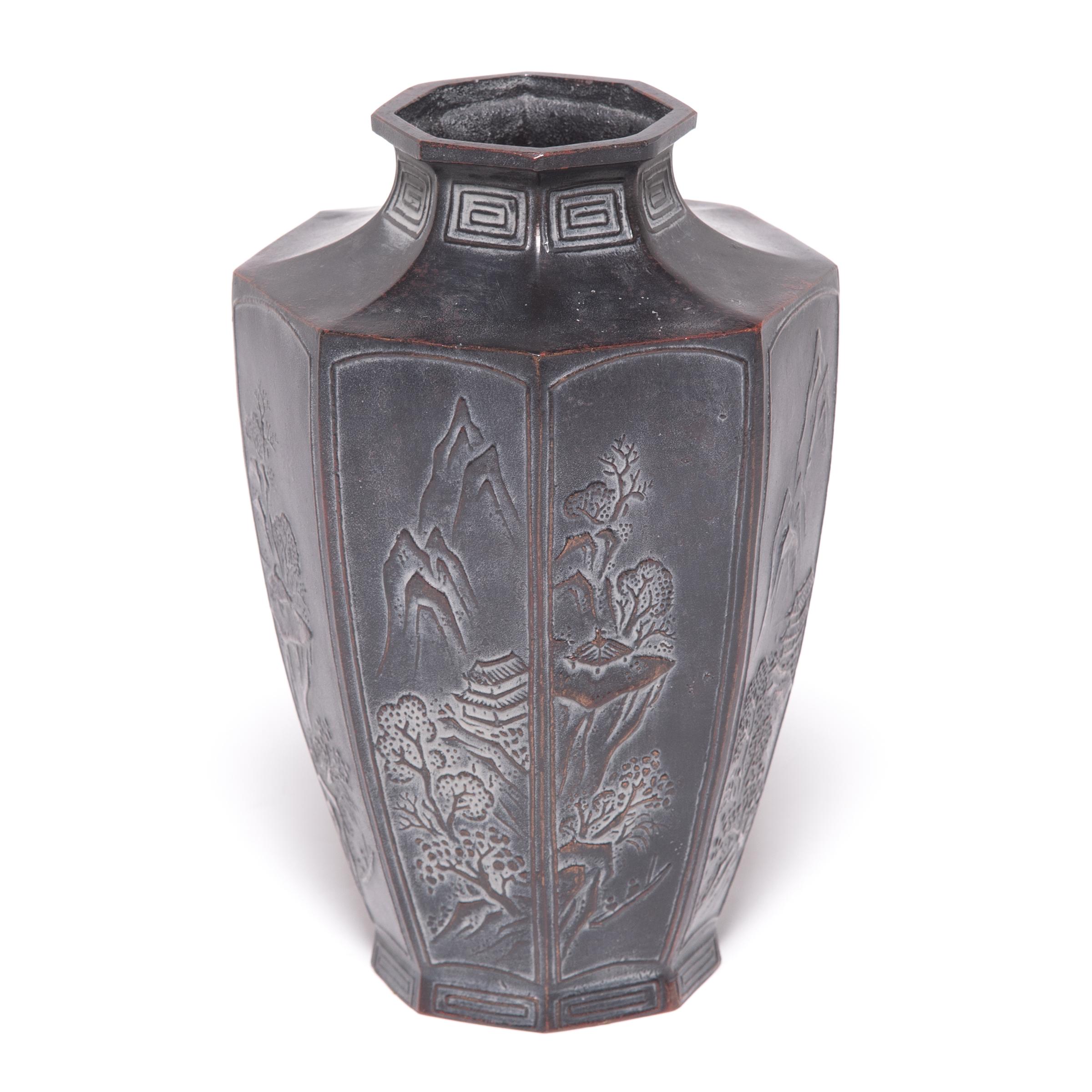 Traditional Japanese metalworkers are renowned for creating specialized alloys that elevated the art of refining, molding, and casting metals. An alloy of zinc and copper gives this octagonal vase its rich dark color, intricately decorated with
