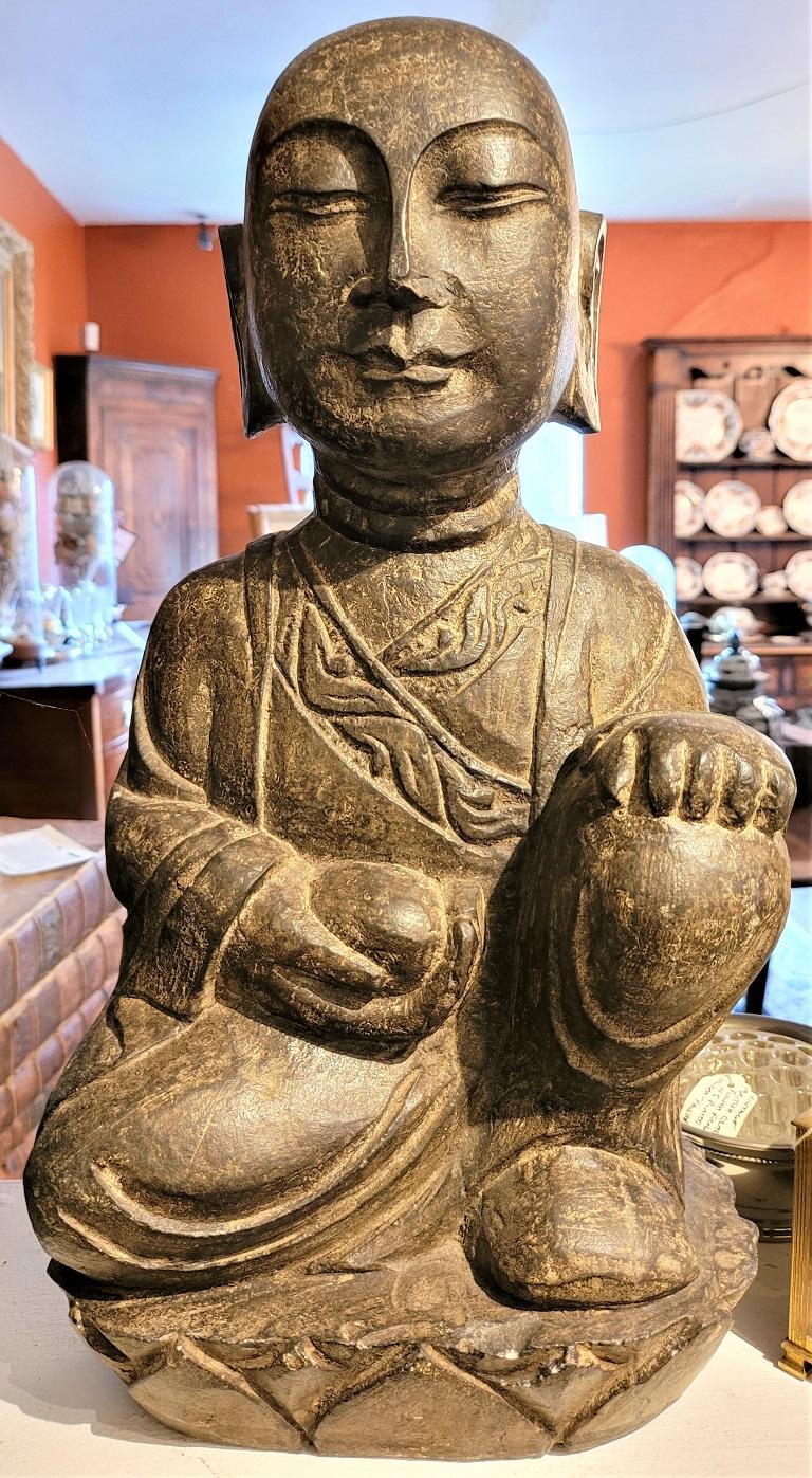 Presenting a lovely early 20th century Japanese stone carved Buddha.

Made of green/brown solid stone… this statue features a kneeling Buddha with one hand on his bended knee and the other holding an offering.

Probably made in the first quarter