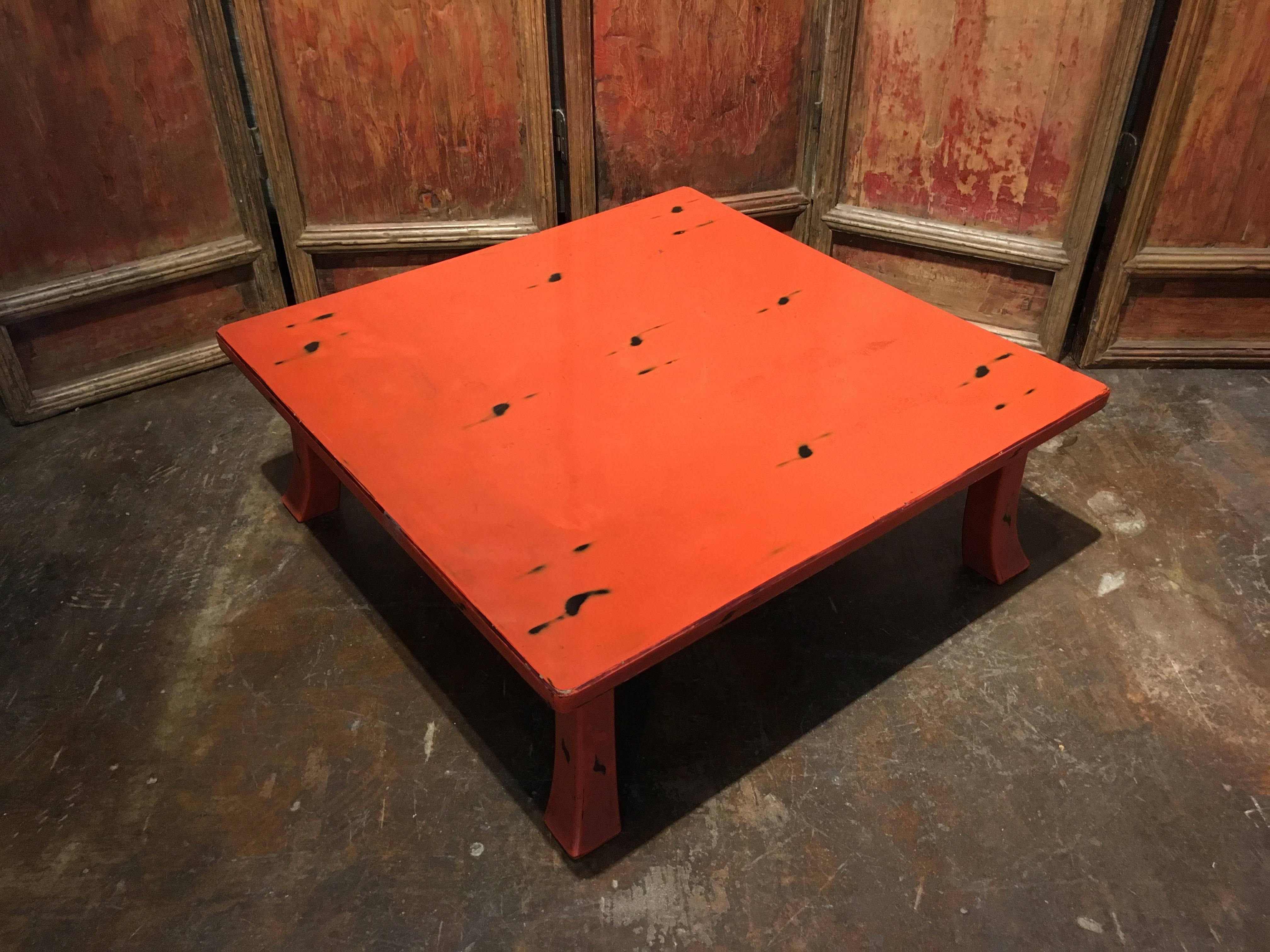 A stunning Japanese 1920s Taisho period negoro lacquer table. Originally used as a tea table, and bearing the hallmarks of use. 
The low square table of tradition design, with a large square top over slightly tapered and flared legs, calling to