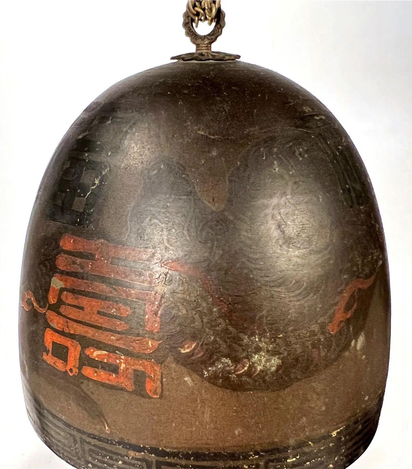 An early 20th century Japanese temple gong suspended in a metal pagoda style arch with calligraphy on the bell and frame at top. Dragon across the arch and figure on base.
Dimensions: 13