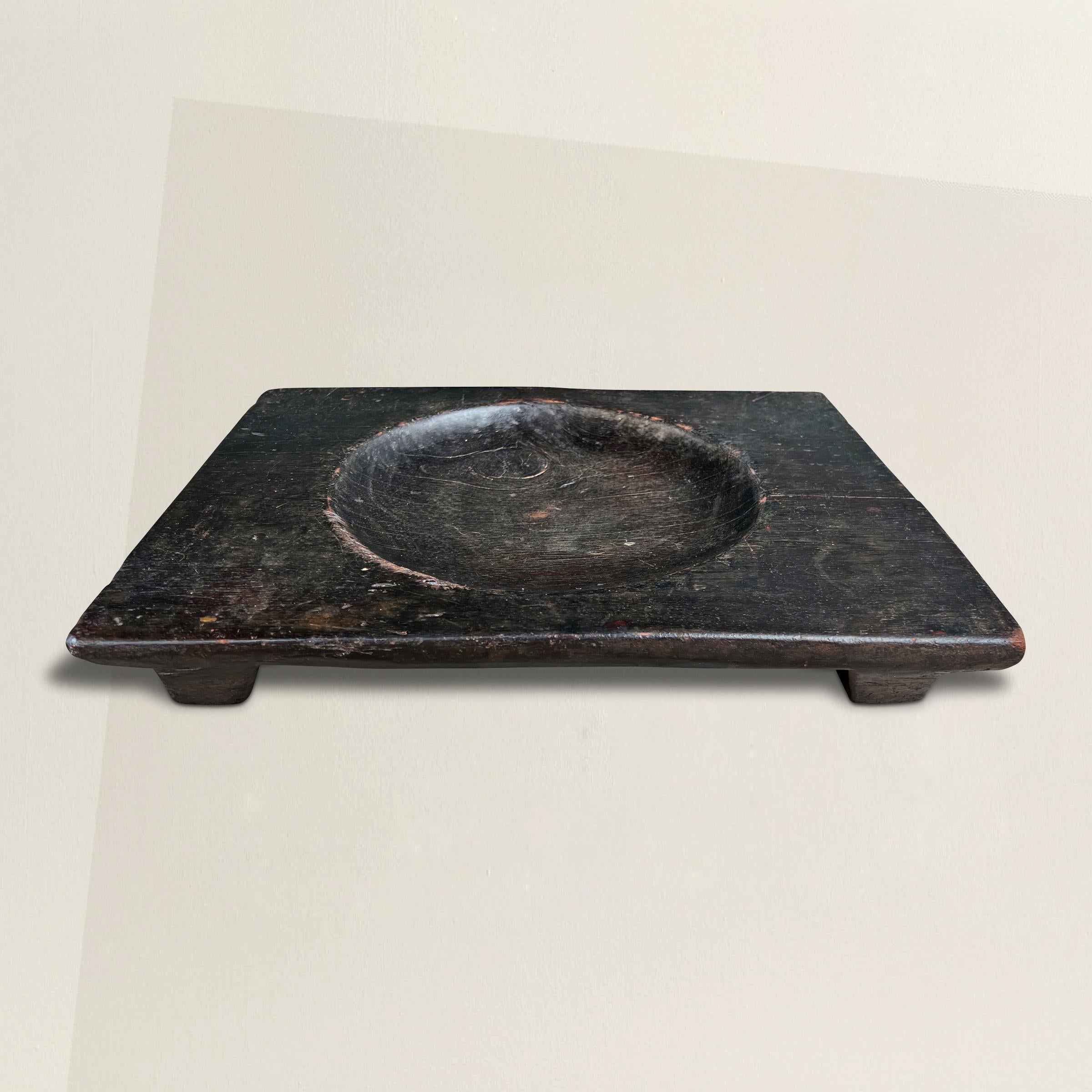Ein schickes und modernes japanisches, handgeschnitztes Holztablett des frühen 20. Jahrhunderts mit rechteckiger Form, das auf zwei Kufen steht und in der Mitte eine runde, konvexe Schale hat.  Auf einer Seite befinden sich mehrere Messerspuren, die