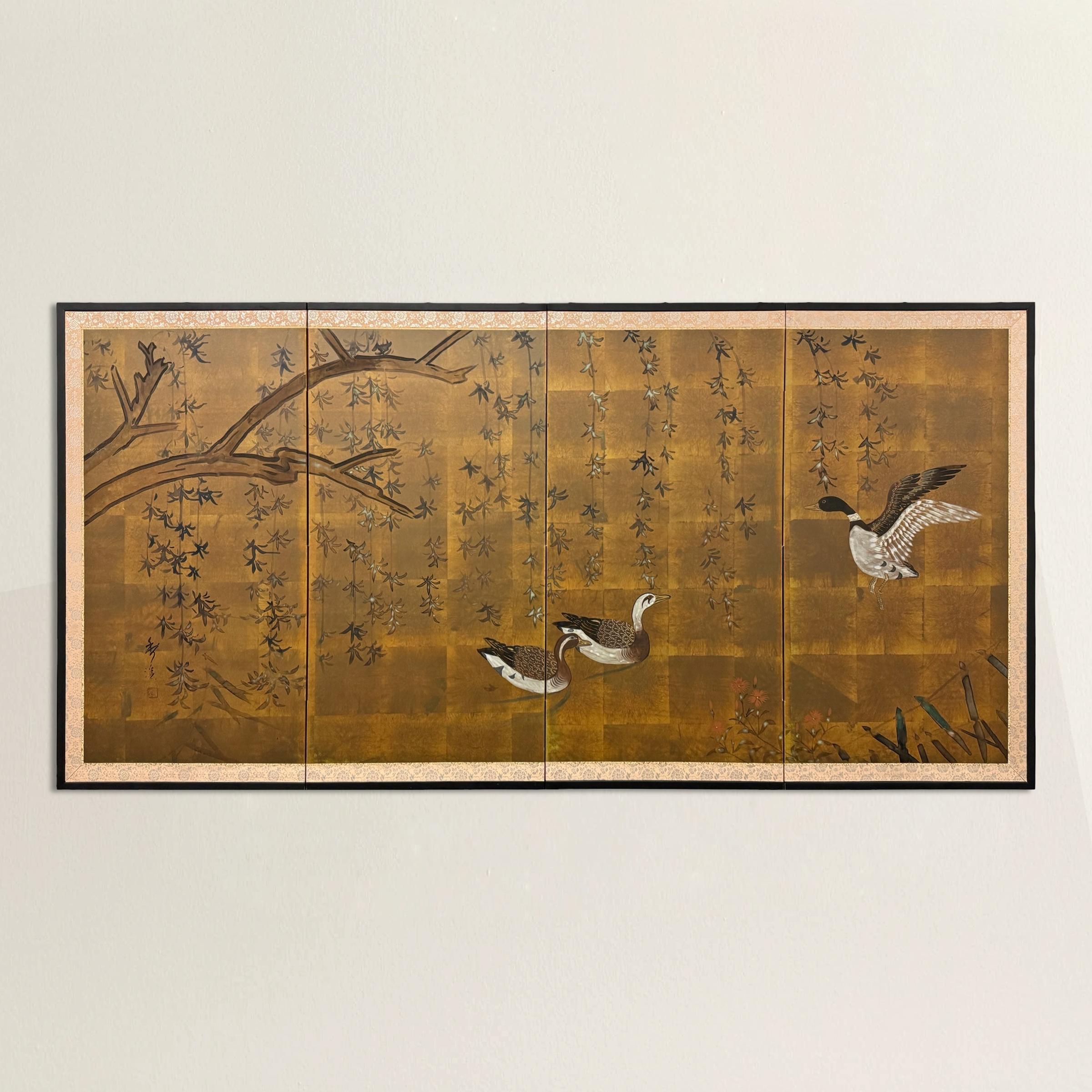 This early 20th-century Japanese byobu screen captures a serene moment in nature, with a large willow tree casting its graceful branches over a secluded cove. Three playful ducks gather at the water’s edge, while a small cluster of red flowers