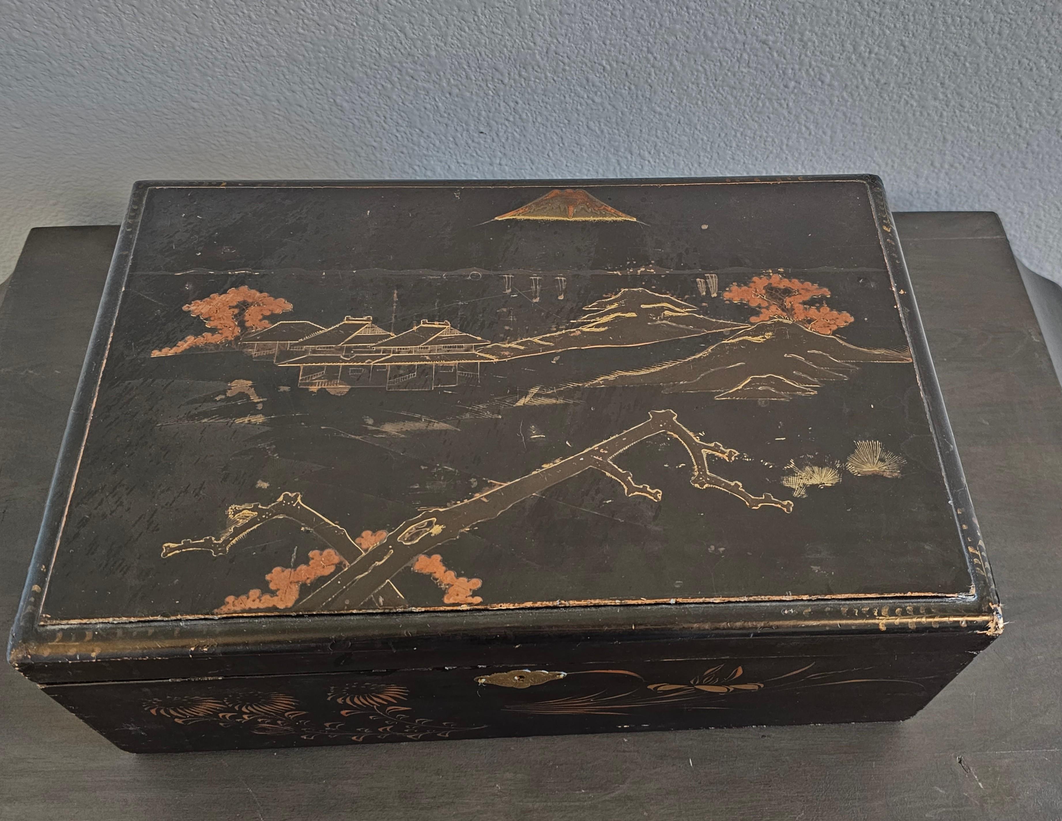 A scarce antique, circa 1900, Japanese black lacquered wood writing slope / travel desk / document box. 

Born in Japan in the early 20th century, influenced by English Colonial Regency era campaign furniture, rectangular chest form, having a
