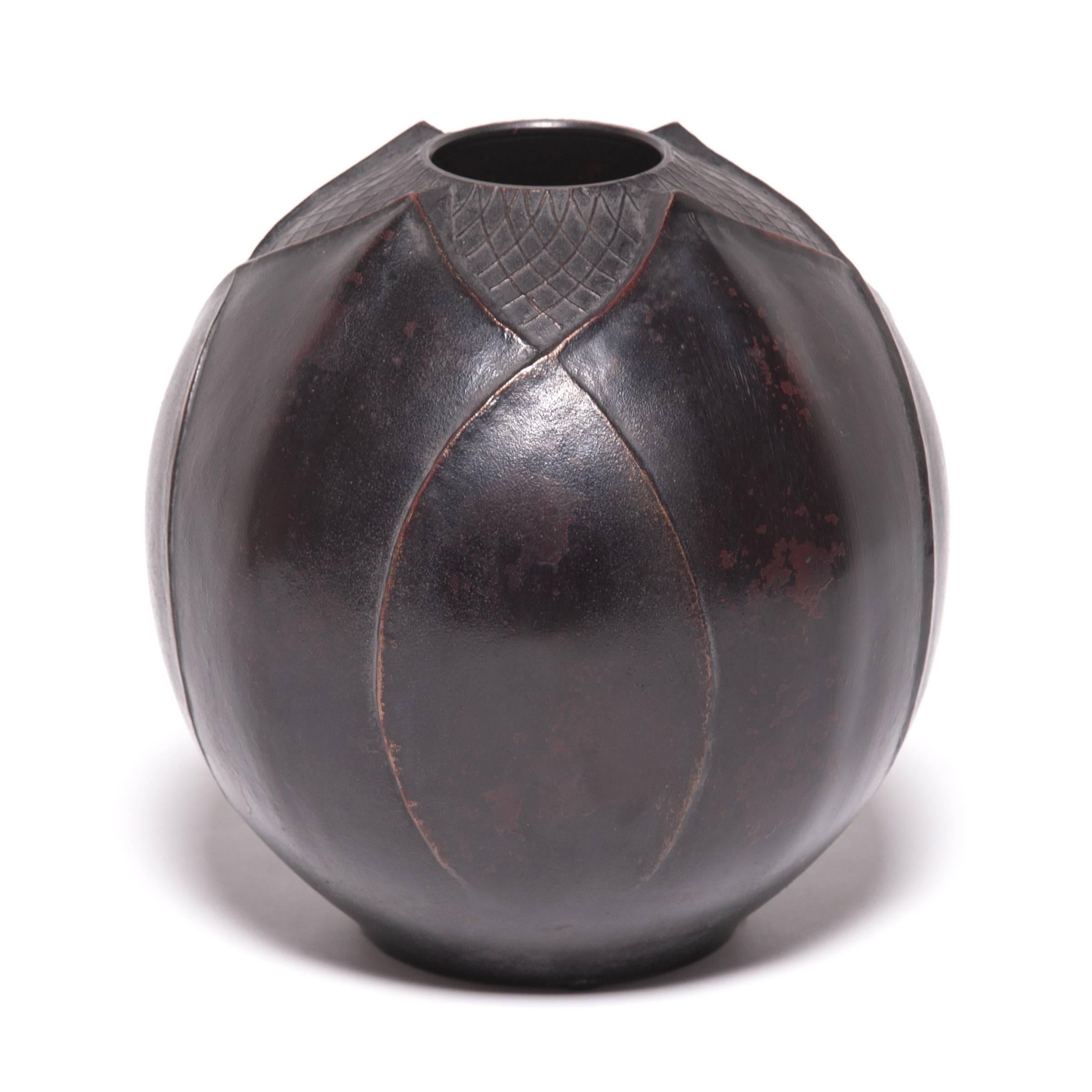 Traditional Japanese metalworkers are renowned for creating specialized alloys that elevated the art of refining, molding, and casting metals. An alloy of zinc and copper gives this metal vessel its rich dark color, cast in the shape of lotus flower