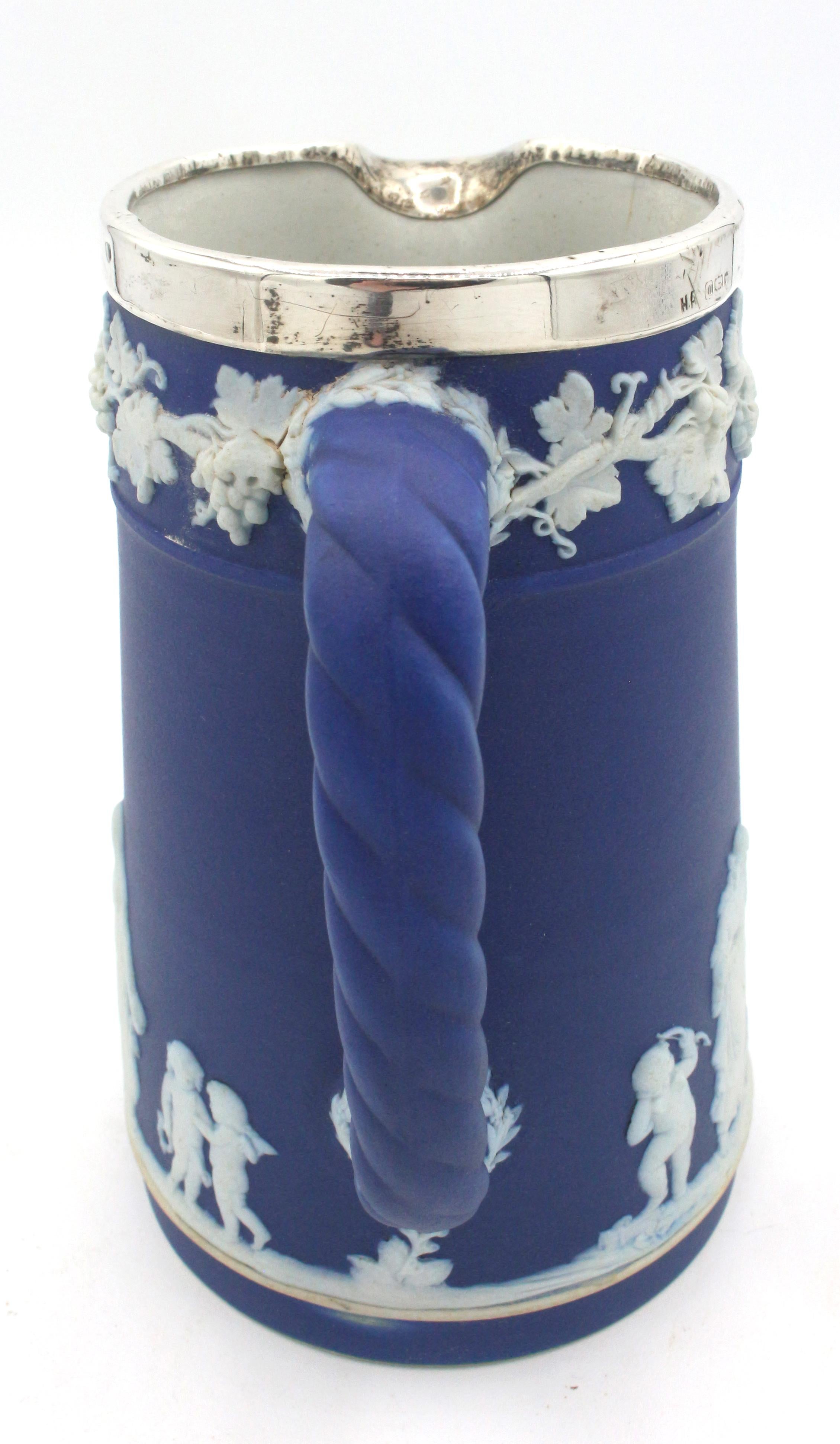 Deep blue Jasperware Wedgwood pitcher with sterling rim, London 1927. Rope handle; grapes & vines entwine with top while Greco-Roman figures adorn the body. Impressed 