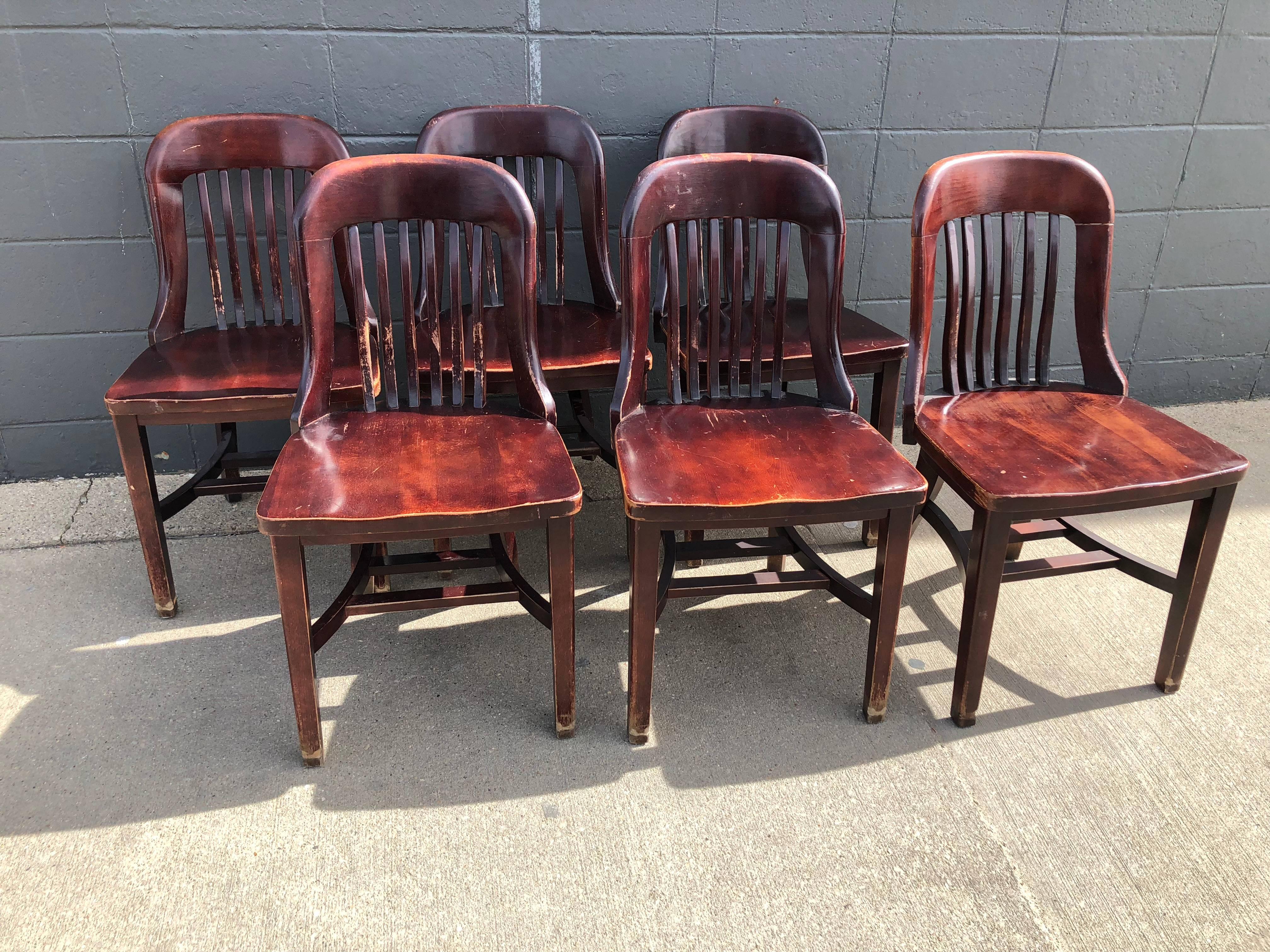 Early 20th century jury chairs from midwestern courtroom. Set of six. Sturdy and significant oak, richly stained and varnished. Classic lines and pedigree. Built for comfort and long sitting spells. What trials of crimes and punishment were they sat