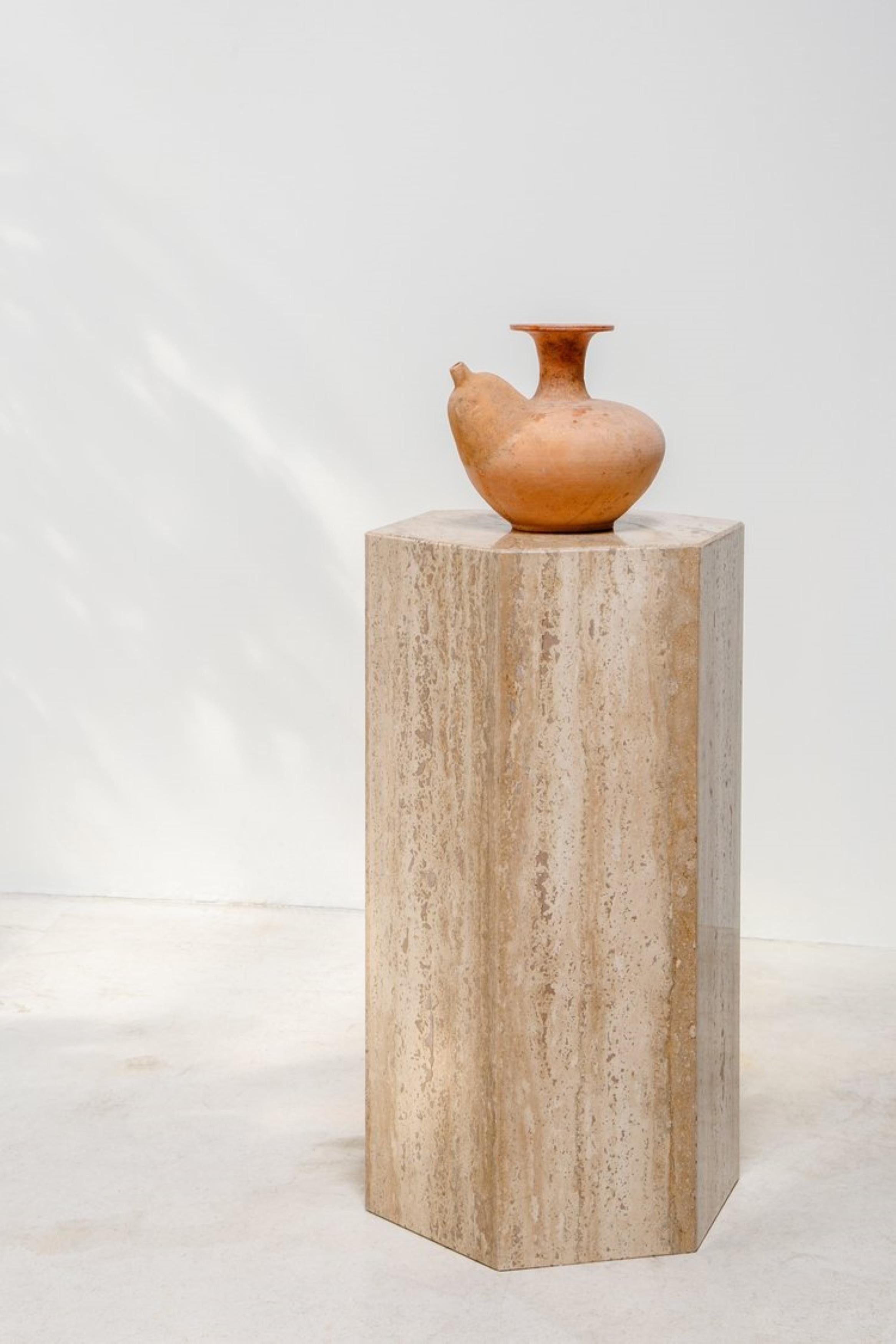 This early 20th-century kendi is a traditional Southeast Asian terracotta water pitcher featuring a bulbous body, and side spout for easy pouring and speaks to its rich history. Kndies have been used in Southeast Asia for centuries, for daily water
