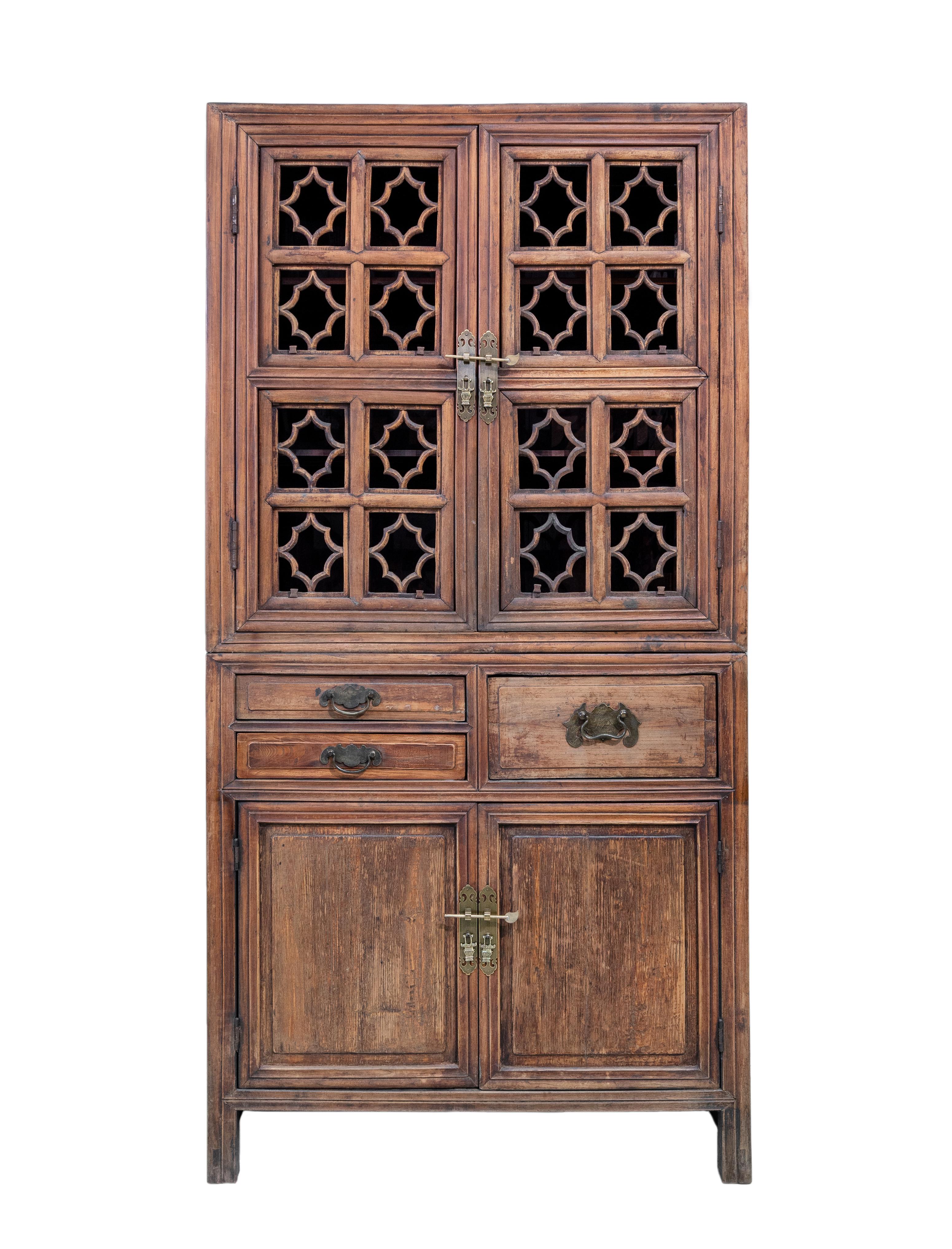 An early 20th century kitchen cabinet from Zhejiang, China. This cabinet has an unusual lattice pattern on the front and sides, and the lattice panels has wooden pegs which makes them removable. The openwork on the top half makes it suitable for