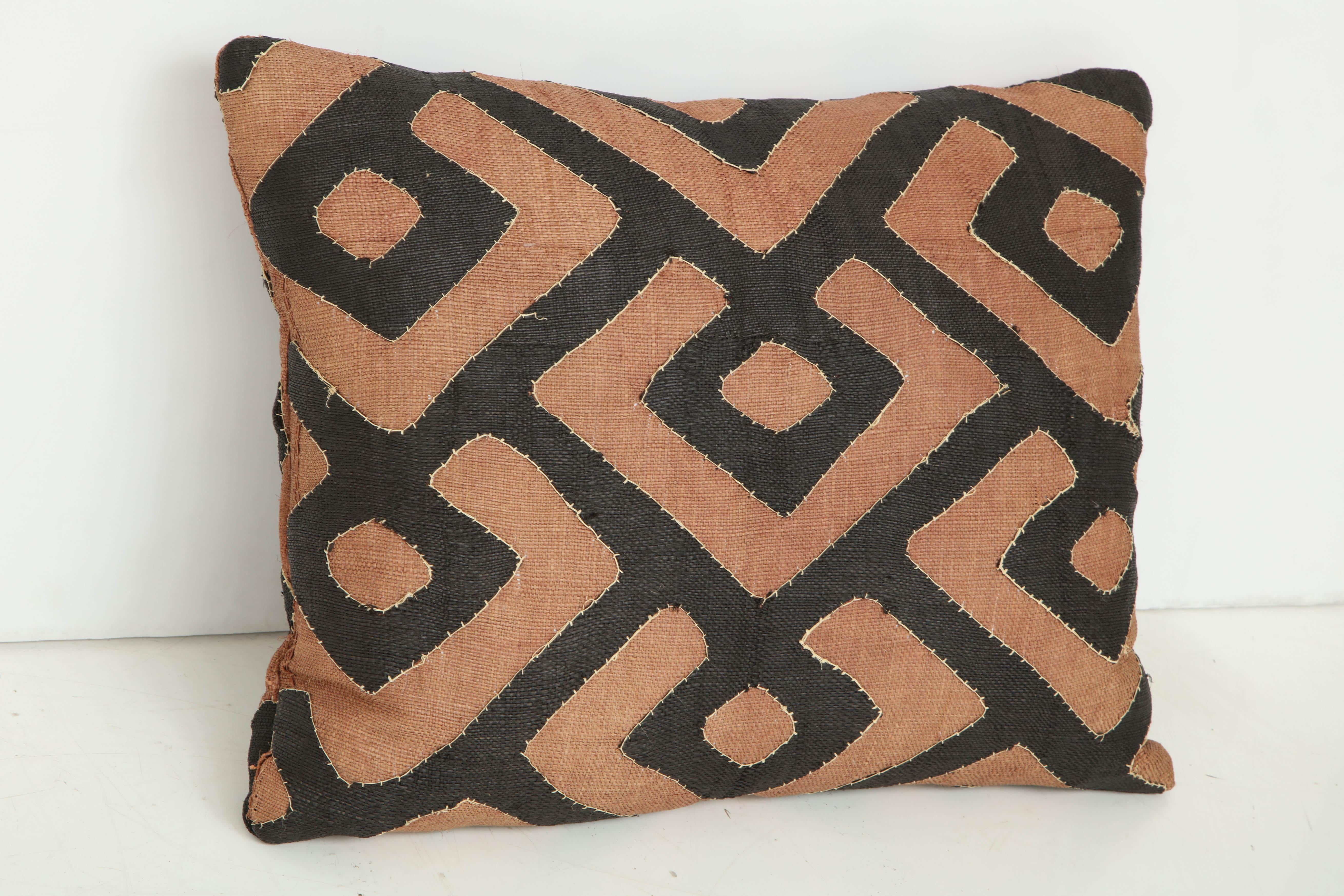Early 20th century Kuba raffia cloth pillow, brown and black.