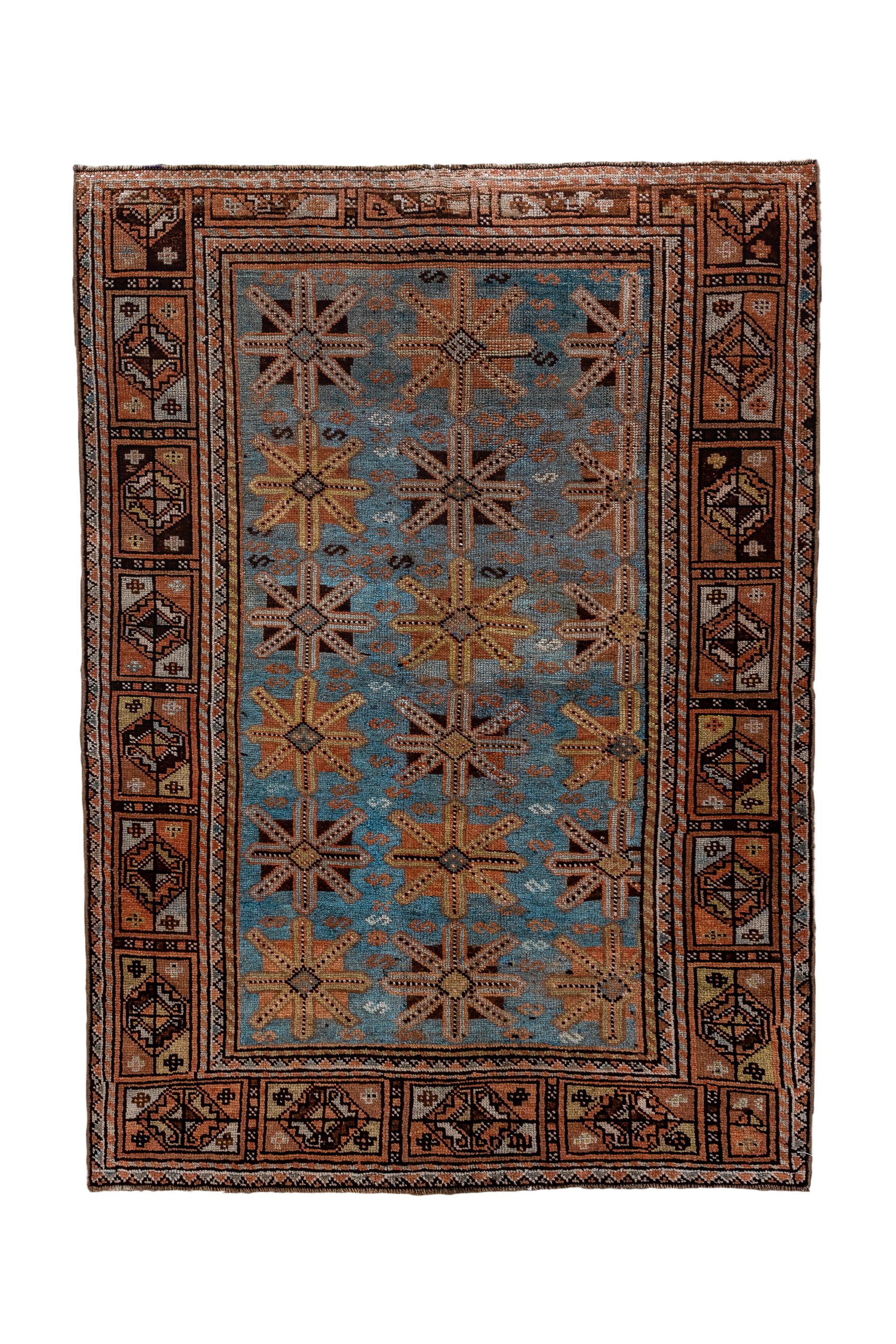 Looks like a Baluchi version of a Turkmen rug, but with a cerulean blue field it is probably Kurdish, with three columns of simple “Union Jack” guls, and a border adapted from the “Aina gul” Turkmen pattern as well. Straw, blue and ecru touches.