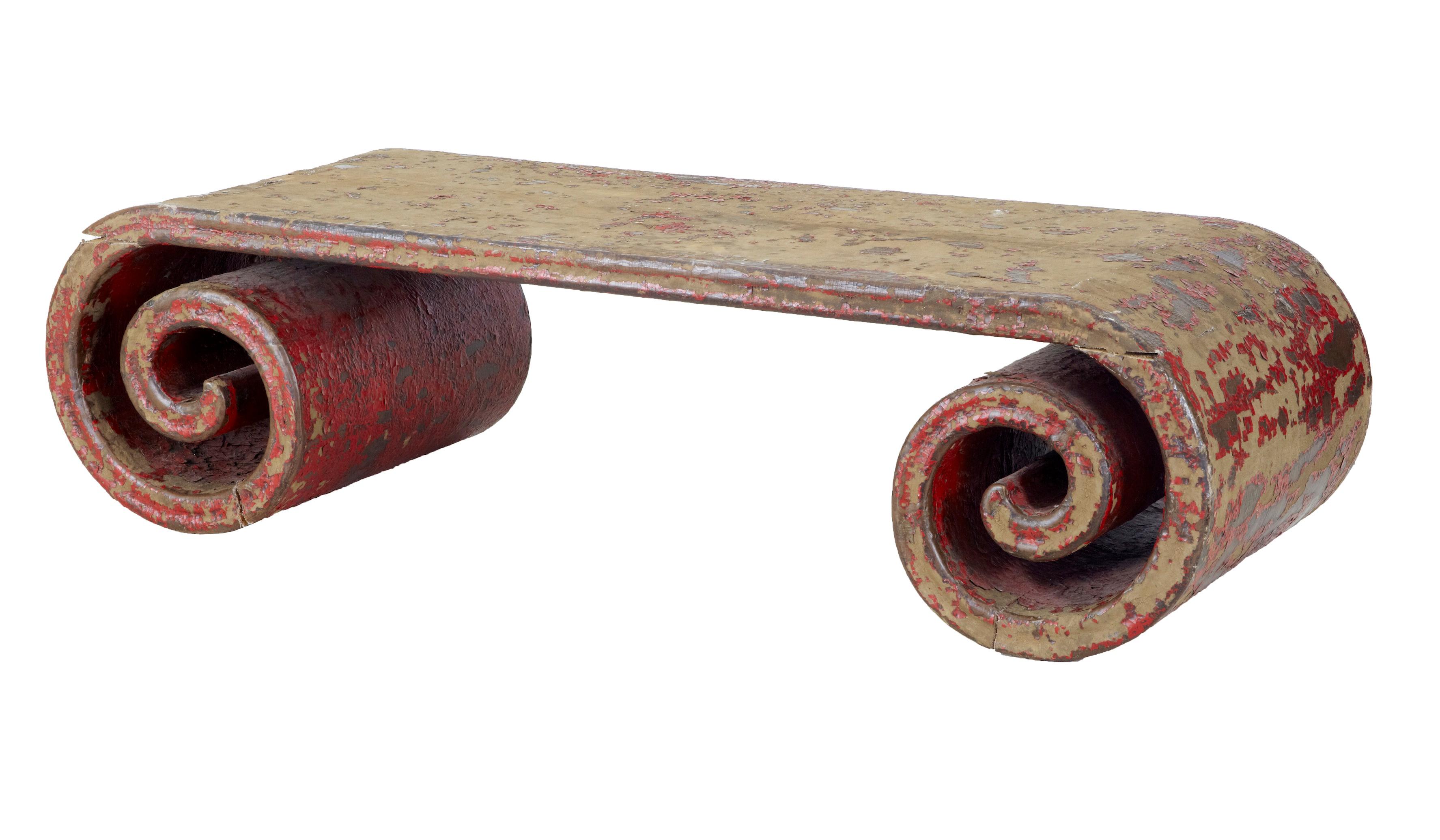 Here we have a unique scrolled low table, possibly Chinese export, circa 1910.
Very heavy canvas covered woodwork, with traces of the original red lacquered finish, now giving its distressed appearance.
Some age separation in the construction