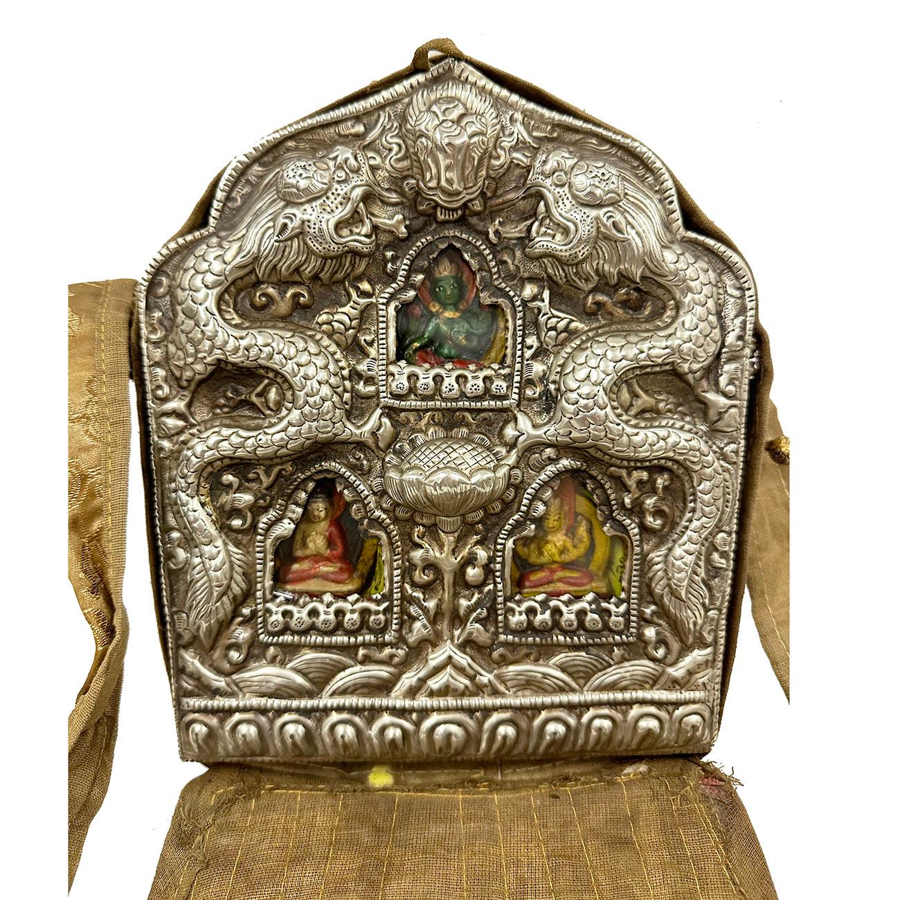 Ghau is a prayer box worn as pendant by Buddhists as portable shrines which can be pray by prayer during their travel. This large Ghau prayer box (travel Buddha shrine) made from Tibetan silver with THREE Buddhas, Turquoise, bronze, red Buddha