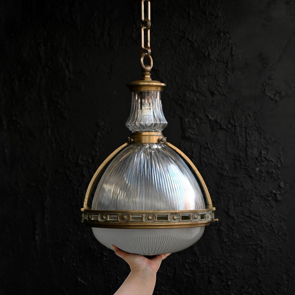 Early 20th Century Large Double Bulb French Holophane Pendant 

This one is big, with a double bayonet light bulb fitting, brass cage and glass Holophane shades which is stamped. The cage can be opened via a hinged clip as shown. With its original