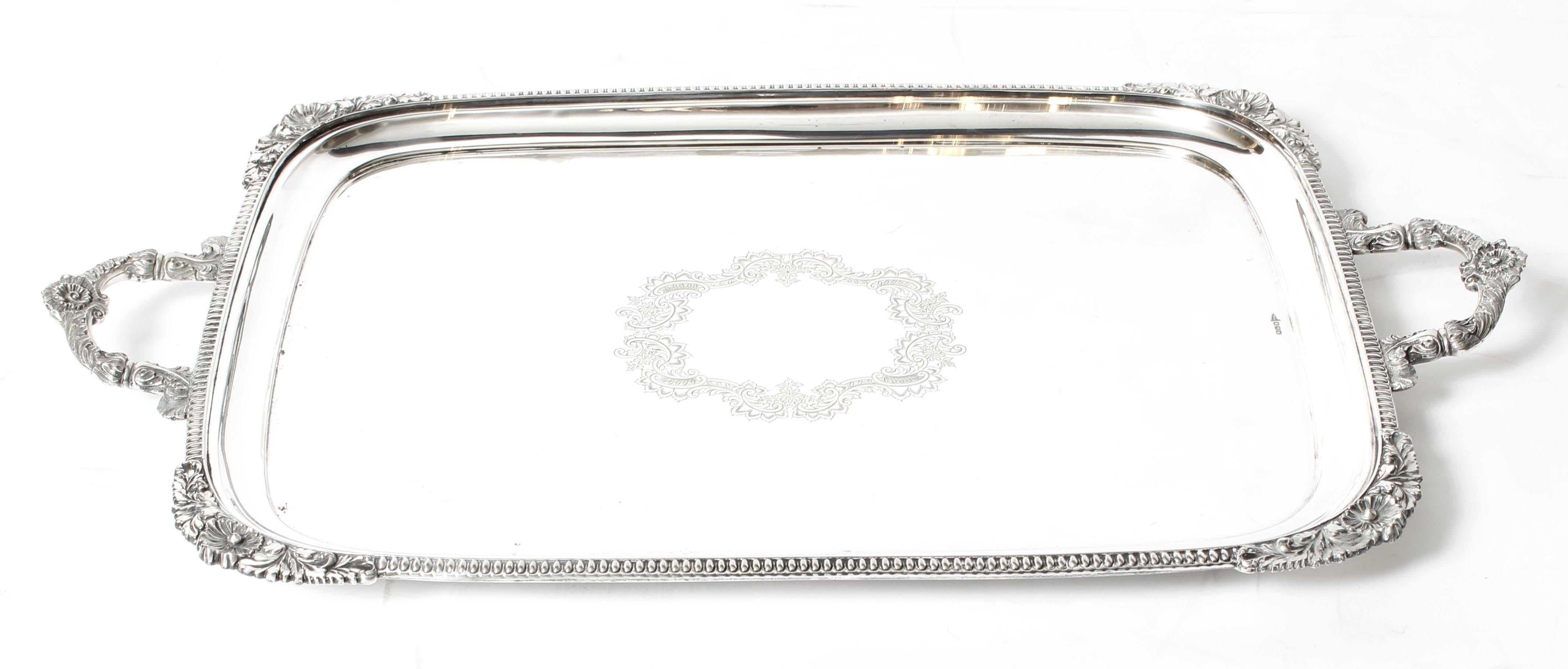 This is a lovely antique large English Edwardian silver plated tray with makers marks of Walker & Hall, Sheffield, dating it to circa 1910.

This large rectangular silver plated tray features fabulous engraved decoration, a deep set decorative