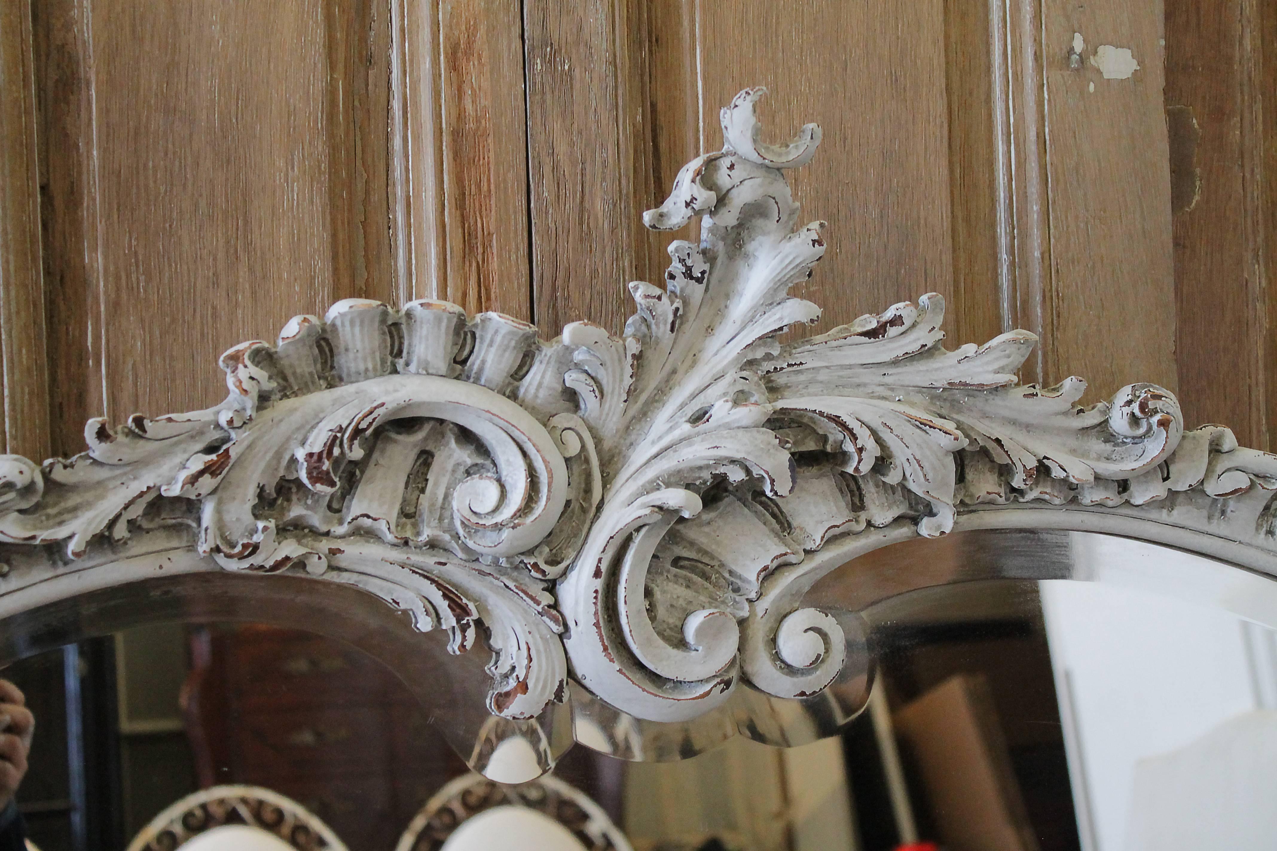 Early 20th century large hand-carved French Rococo style mirror
Painted in an oyster white, with a subtle hue of grey tones, with light distressed edges, and antique glazed patina.
Measures: 70
