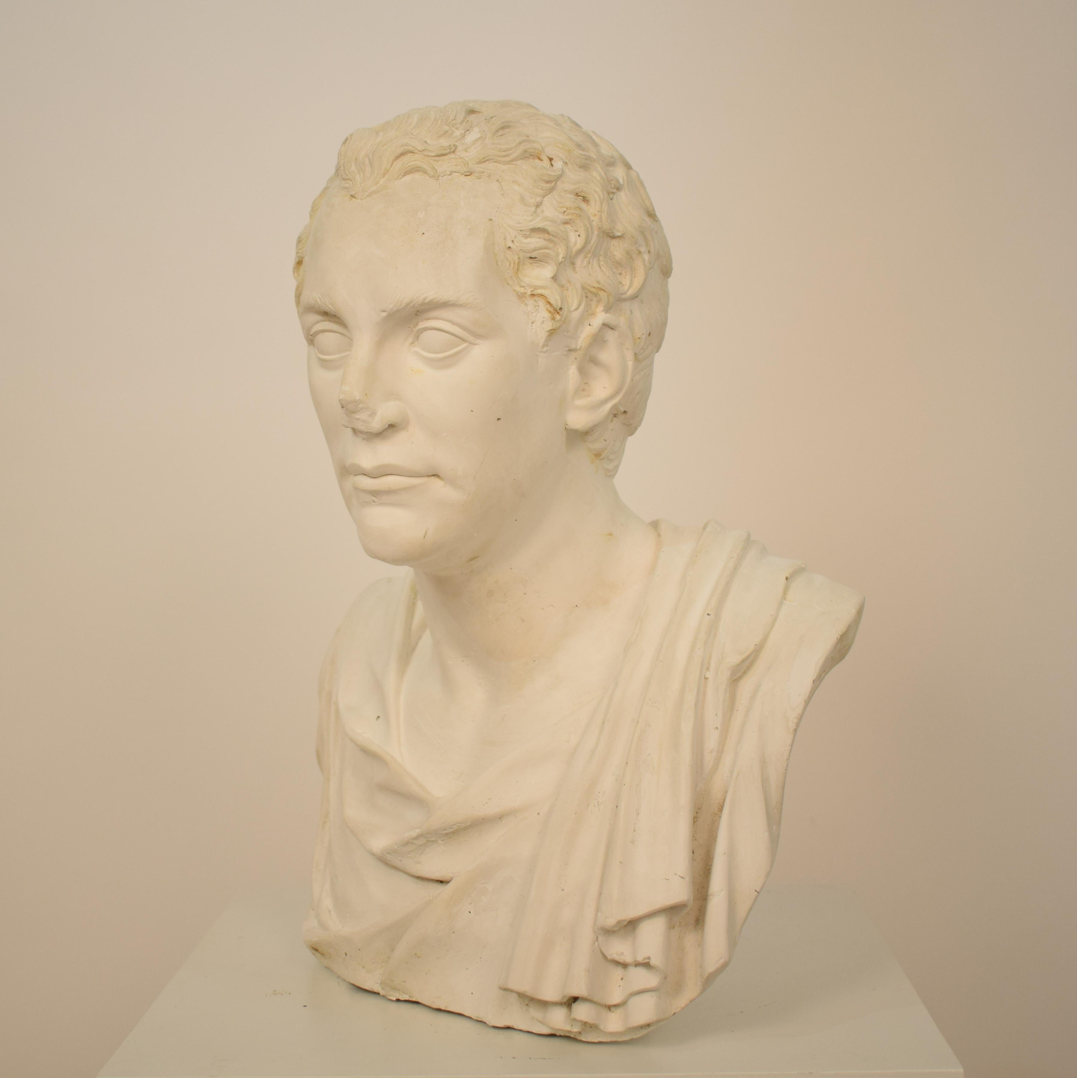This large early 20th century Italian Grand Tour plaster bust of Roman Senator was made in Italy, circa 1930. It is an antique reproduction bust.
The piece is in an authentic condition with wears is use and provides some great Patina.

A unique
