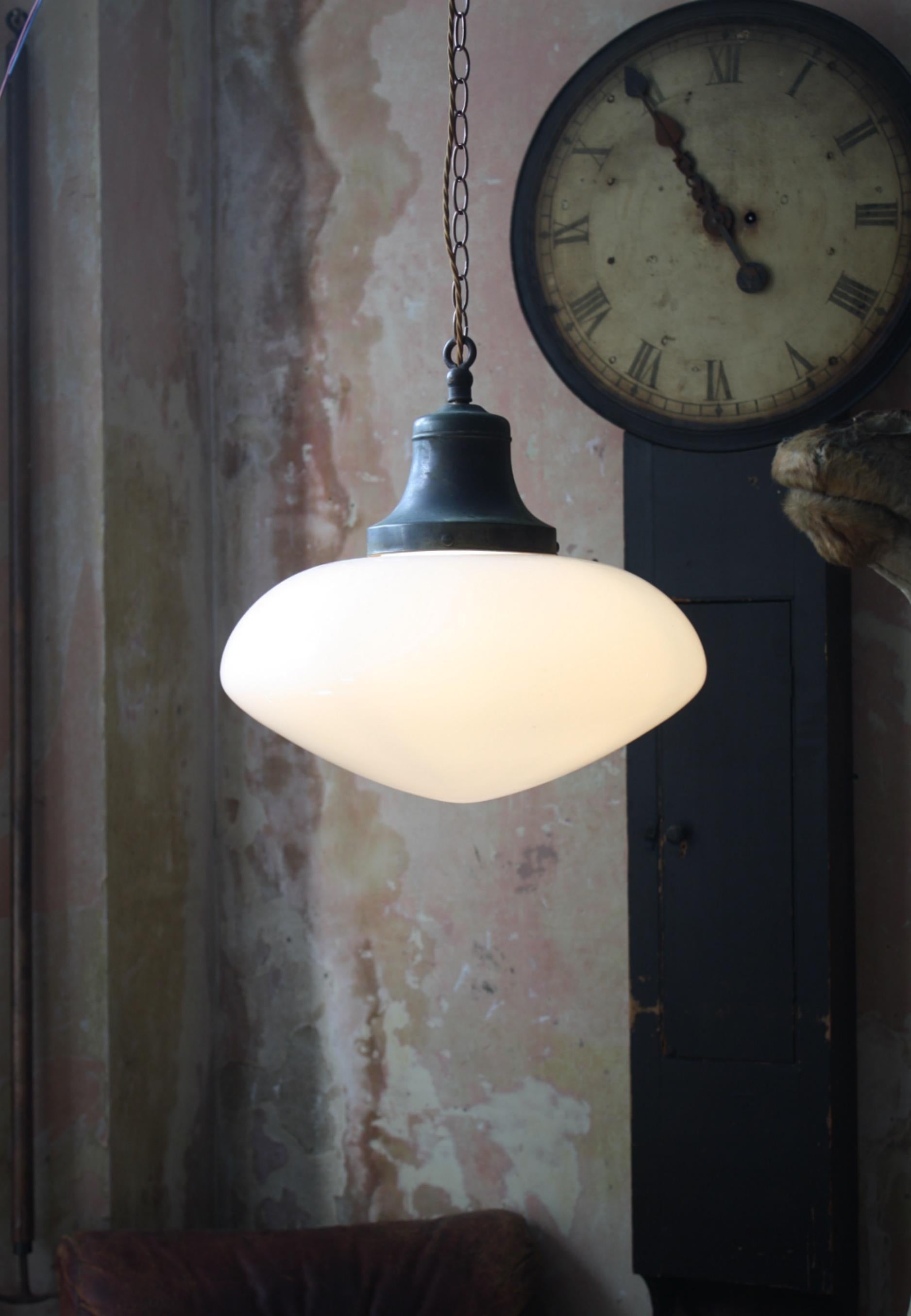 A good quality milk glass pendant with its original copper spun gallery.

First quarter of the 20th century in age, English in origins

Glass in perfect condition, age related verdigris oxidisation to the copper gallery.

The light comes with approx