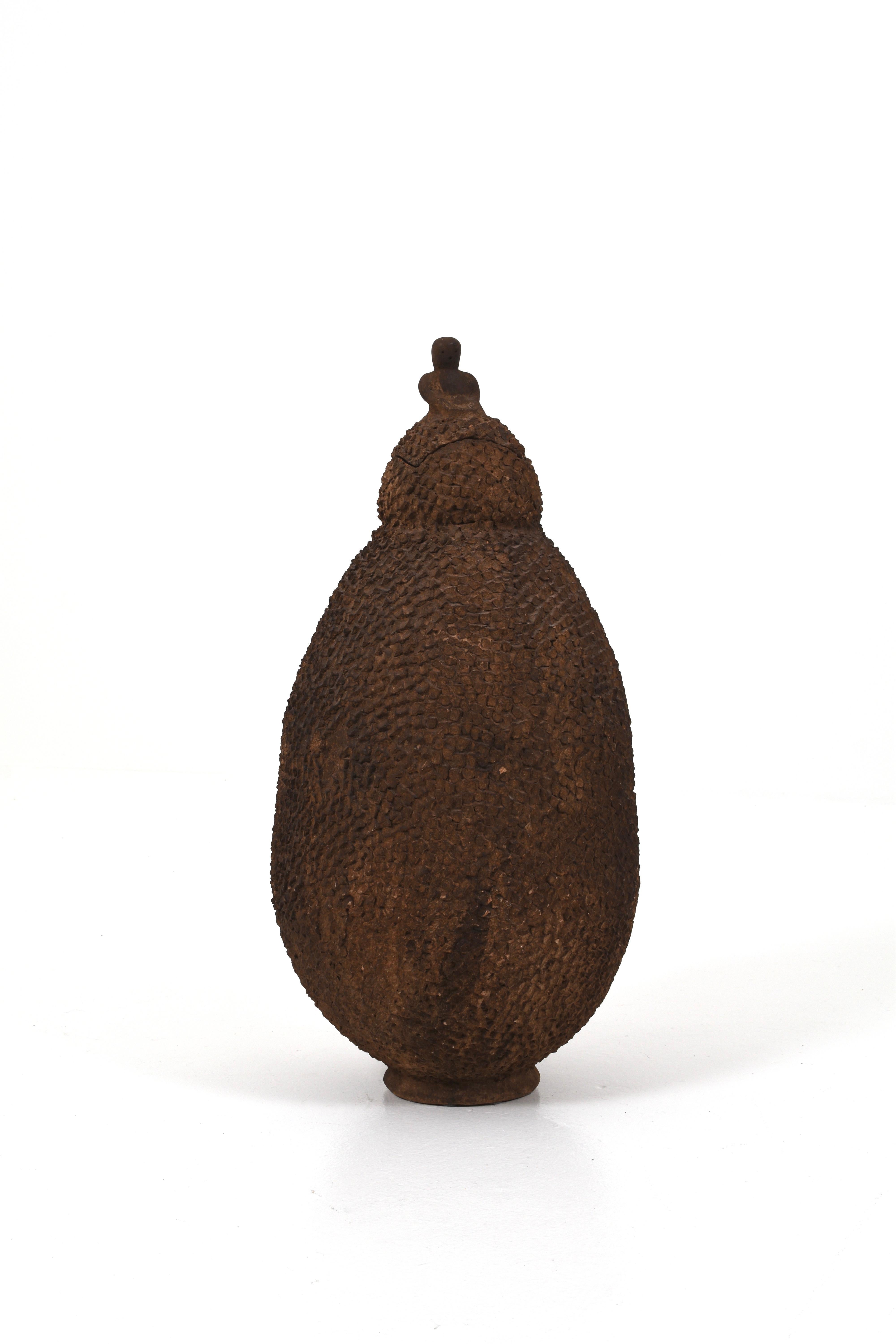 Beautiful large African urn in terracotta made by the Lobi people of Burkina Faso.

This urn is very decorative with a small figure sitting on the lid. The urn is 81 cm high and 45 cm wide. Because it is old, there is some chipping. Please see