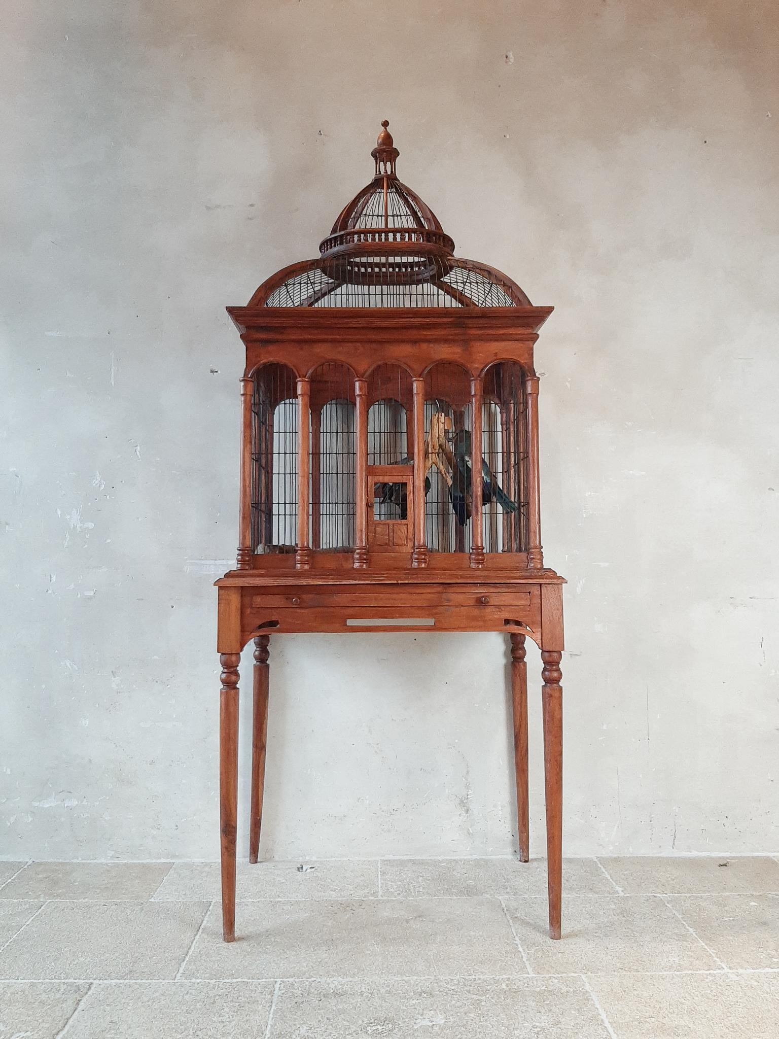 Large, wooden, highly decorative bird cage table from the first half of the 20th century.

Dimensions: H 197 x W 80 x D 53 cm.