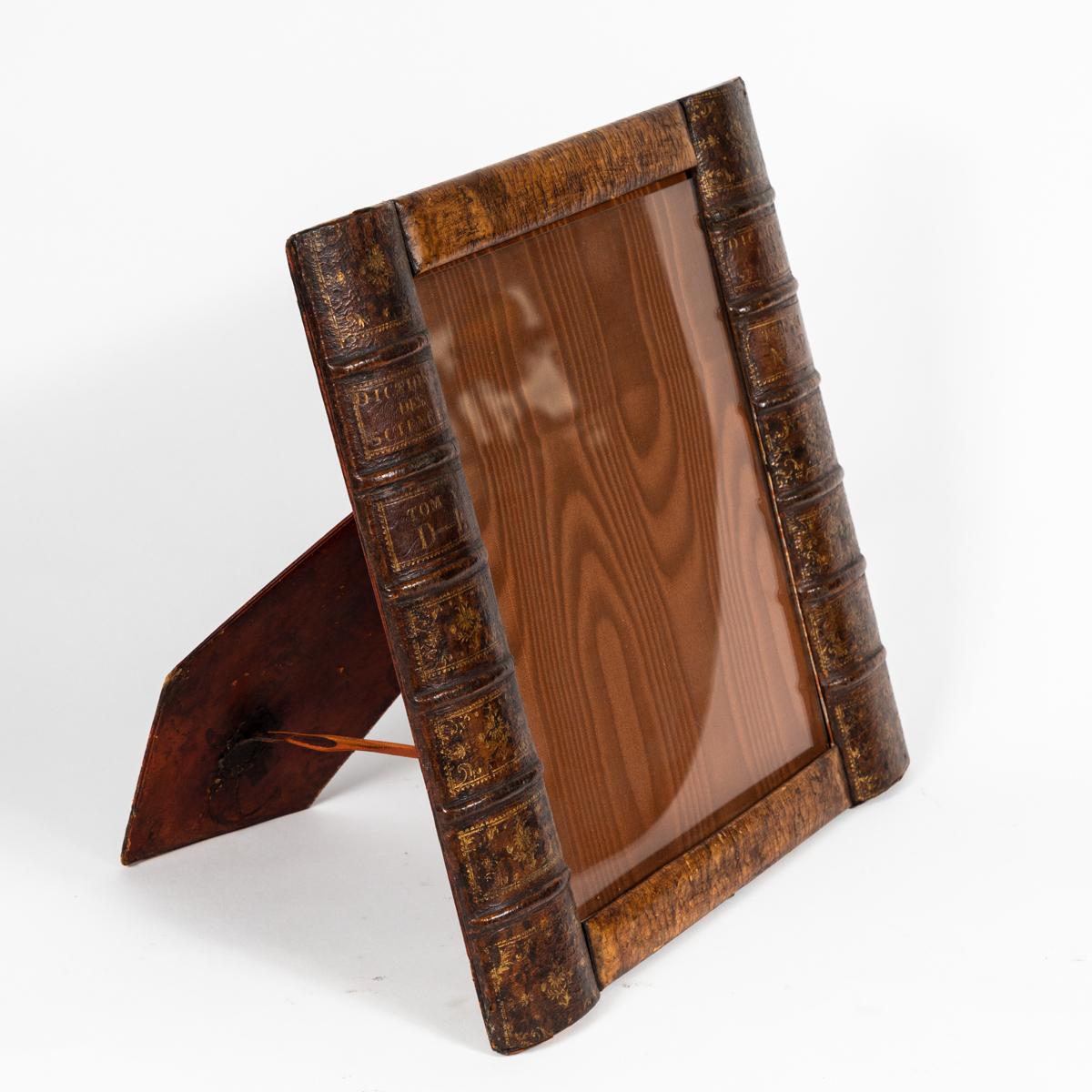 Early 20th century leather book picture frame from England. This piece has acquired a unique patina over its life, furthering the effect of the false book. 