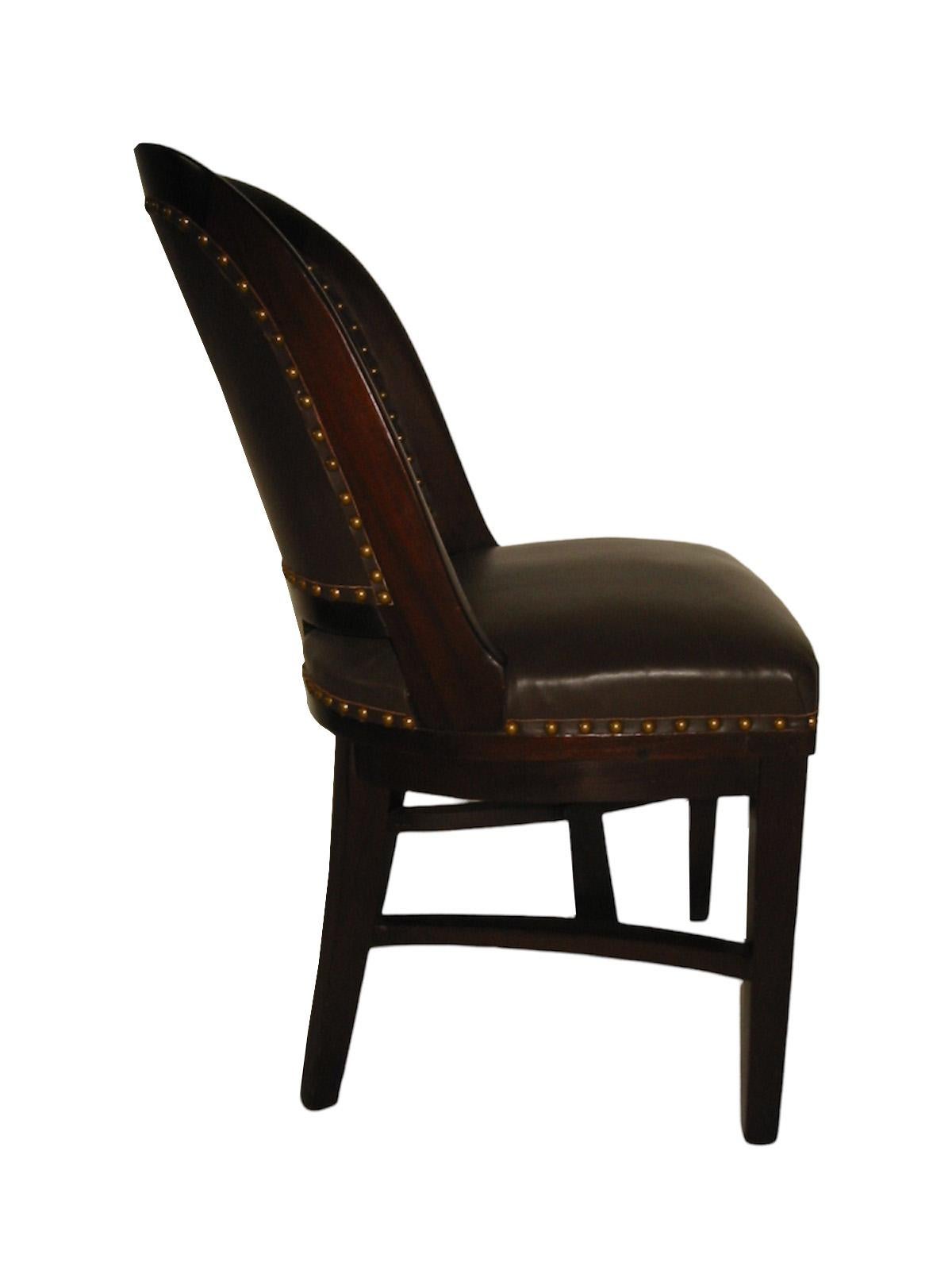 19th century leather bank chair. Beautifully upholstered with a brass nail head trim. 

Property from esteemed interior designer Juan Montoya. Juan Montoya is one of the most acclaimed and prolific interior designers in the world today. Juan Montoya