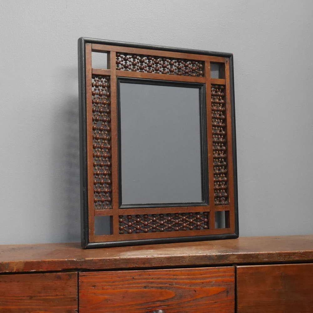 An Aesthetic Movement Mashribiya wall mirror.
A wonderful mirror which would have been retailed by Liberty & Co of London, the frame with an ebonised edge & inner slip, with perforated bobbin-turned Mashribiya panelling.
North African, early 20th