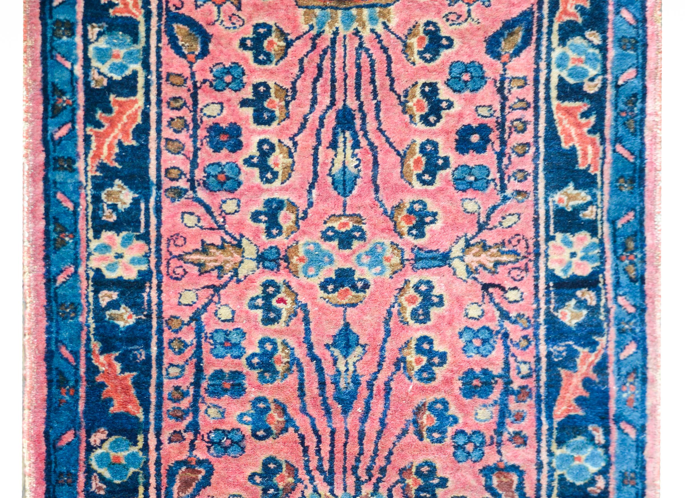 A fantastic early 20th century Persian Lilihan rug with a mirrored Tree-of-life pattern depicting a potted tree with several flowering branches, and surrounded by a beautiful border of leaves and flowers, and all woven in wonderful pinks, creams,