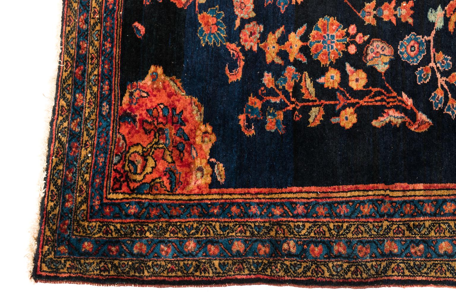 Early 20th century Caucasian rug with floral and geometric motifs, predominantly red hues on black background.
 