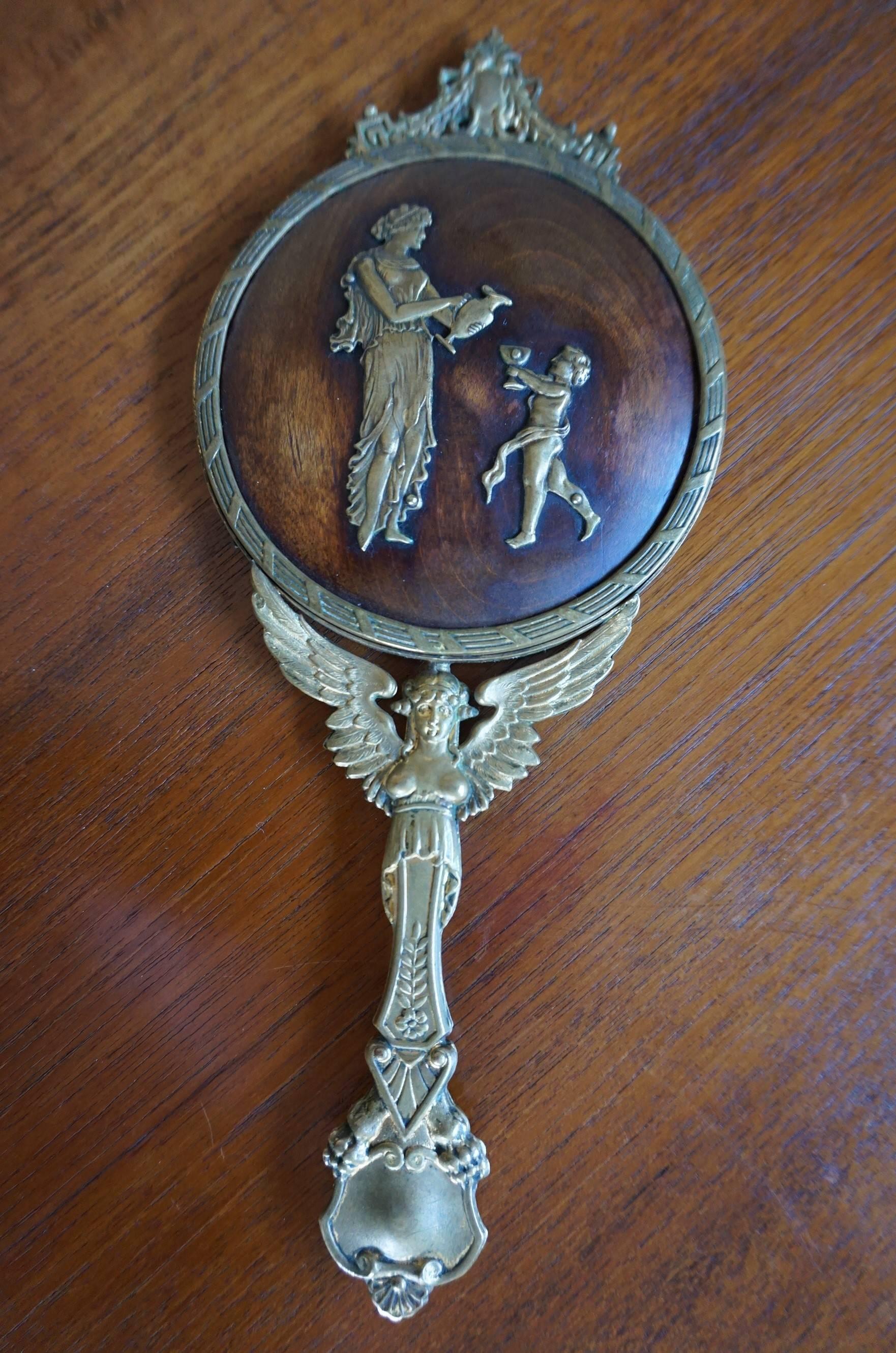 Small but striking little hand-mirror with beveled glass.

If you are looking for a unique gift for yourself or a loved one then this rare Empire style hand mirror could be perfect for you. Both the handle and the ring around the circular, beveled