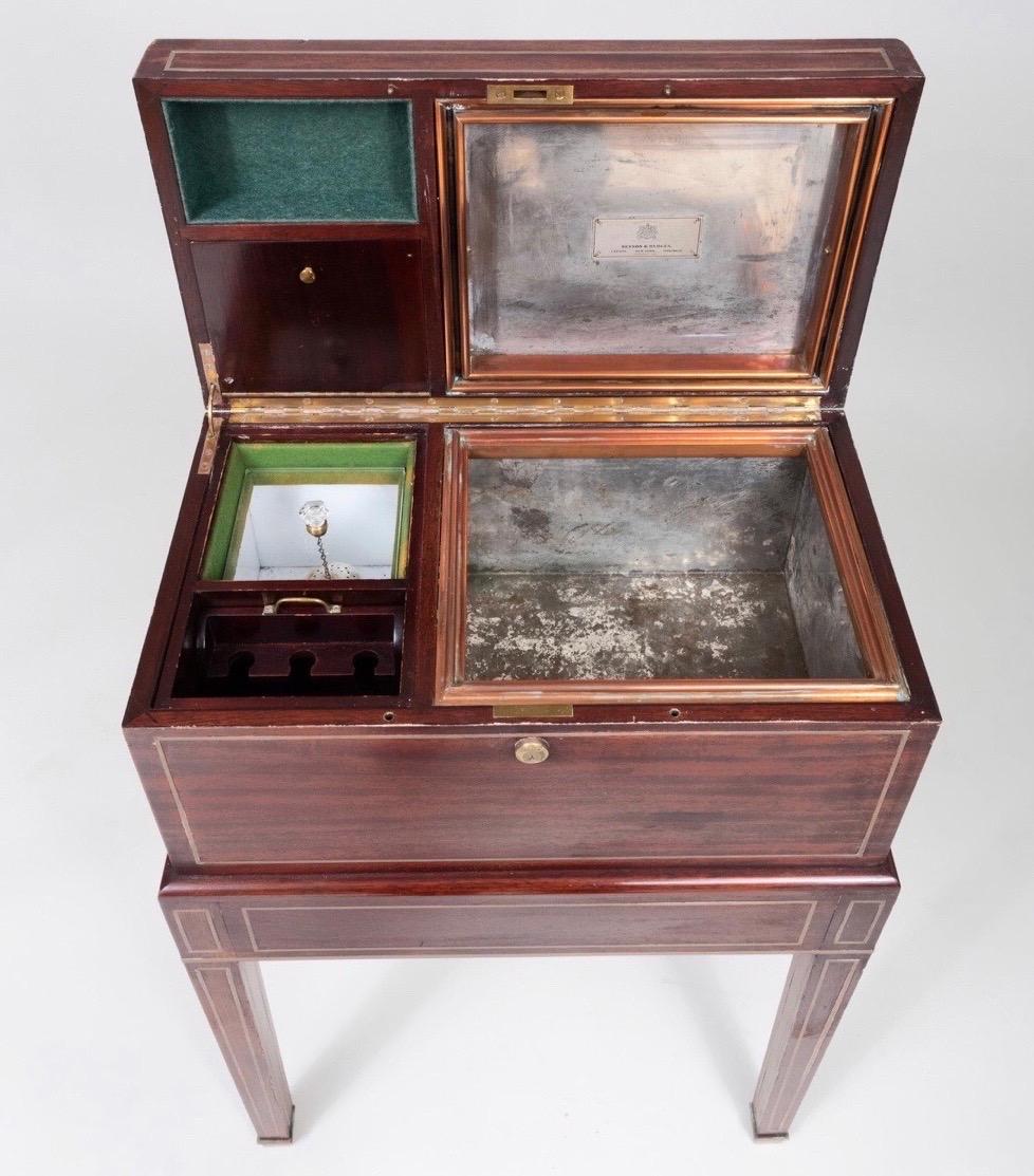 Early 20th century London made brass bound mahogany Humidor by Benson & Hedges. Fitted interior with zinc, copper, Lucite and lined with baise.

Engraved brass plaque: 