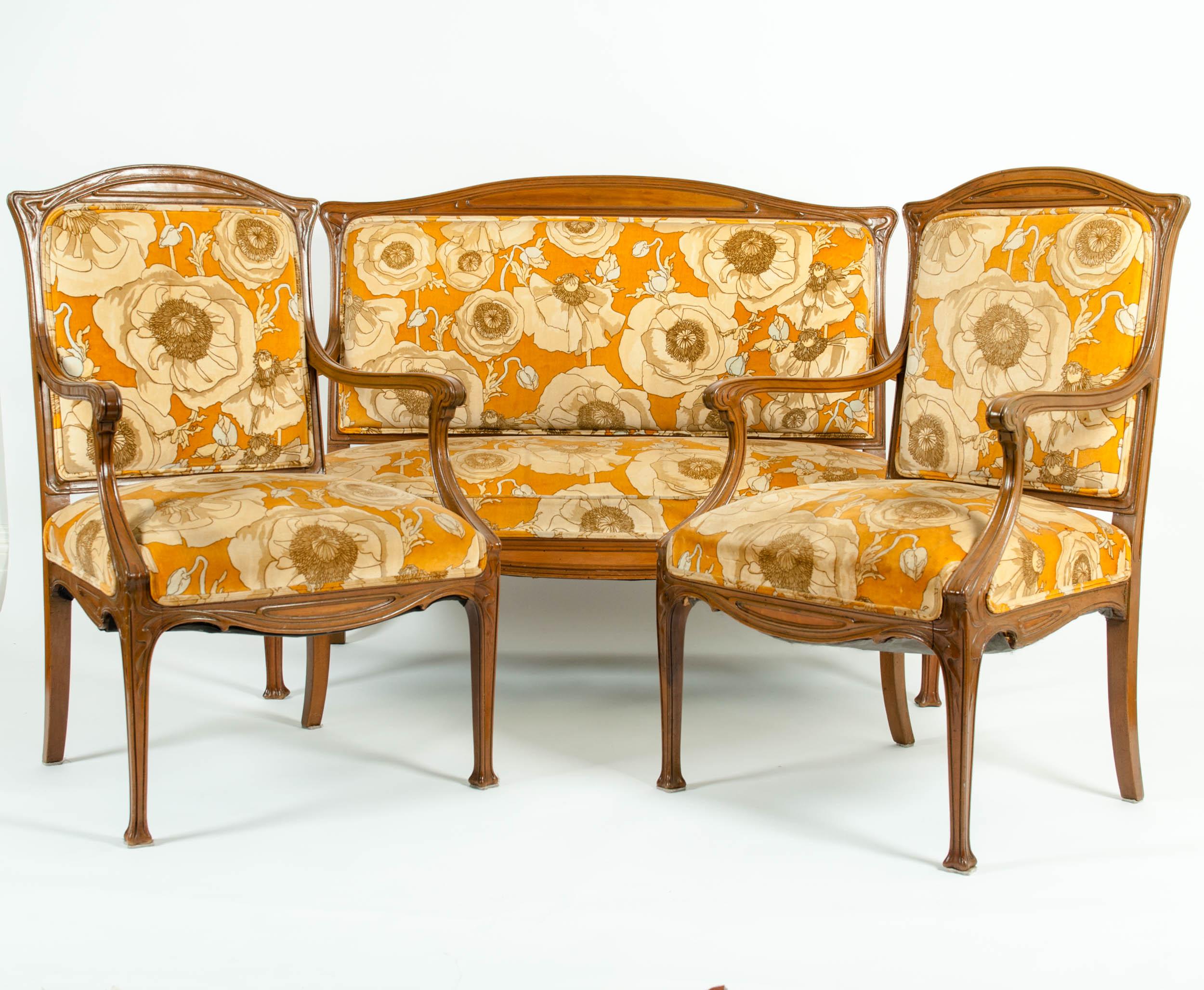 Early 20th century Louis Majorelle three-piece seating set. One settee and two armchairs. Each piece is in great vintage condition with appropriate wear consistent with age / use. Settee measure 50 inches long x 40 inches high x 21 inches wide x 16