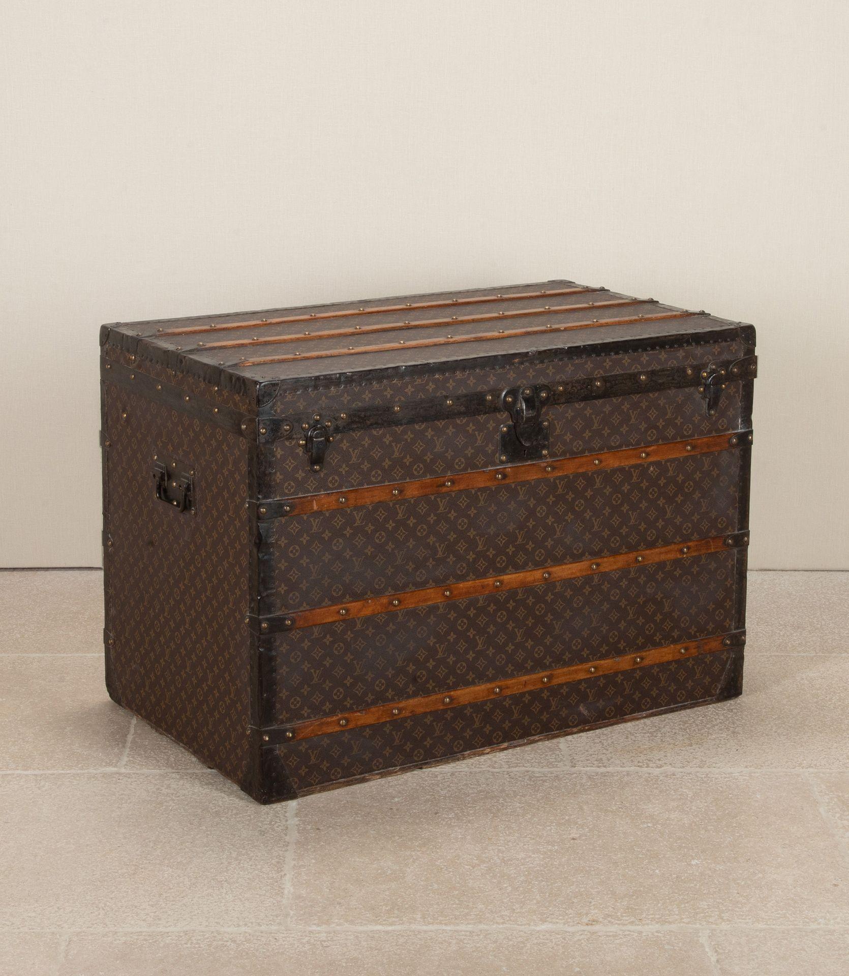 Early 20th Century Louis Vuitton steamer style trunk. LV monogram canvas, brass studs with makers name. Iron handles to sides stamped L.V. Interior paper lined within lift off drawer with handles revealing fully paper lined interior and makers