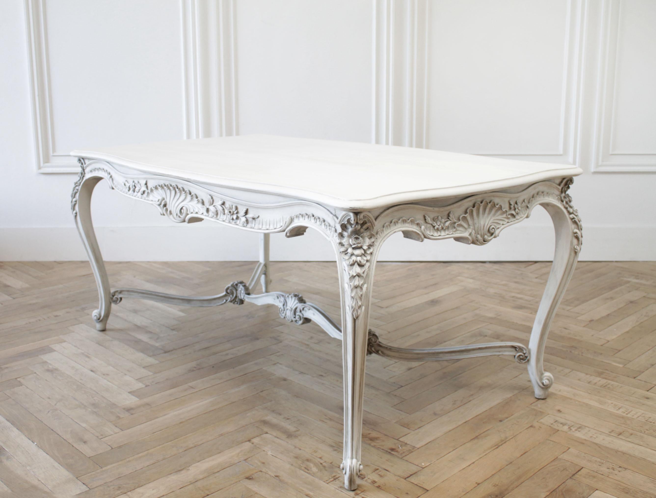 Early 20th century Louis XV carved and painted dining or library table
Painted in a soft oyster white with subtle distressed edges, and antique patina. Beautiful carved apron, and carved stretcher. Great for use as a dining table, library table, or