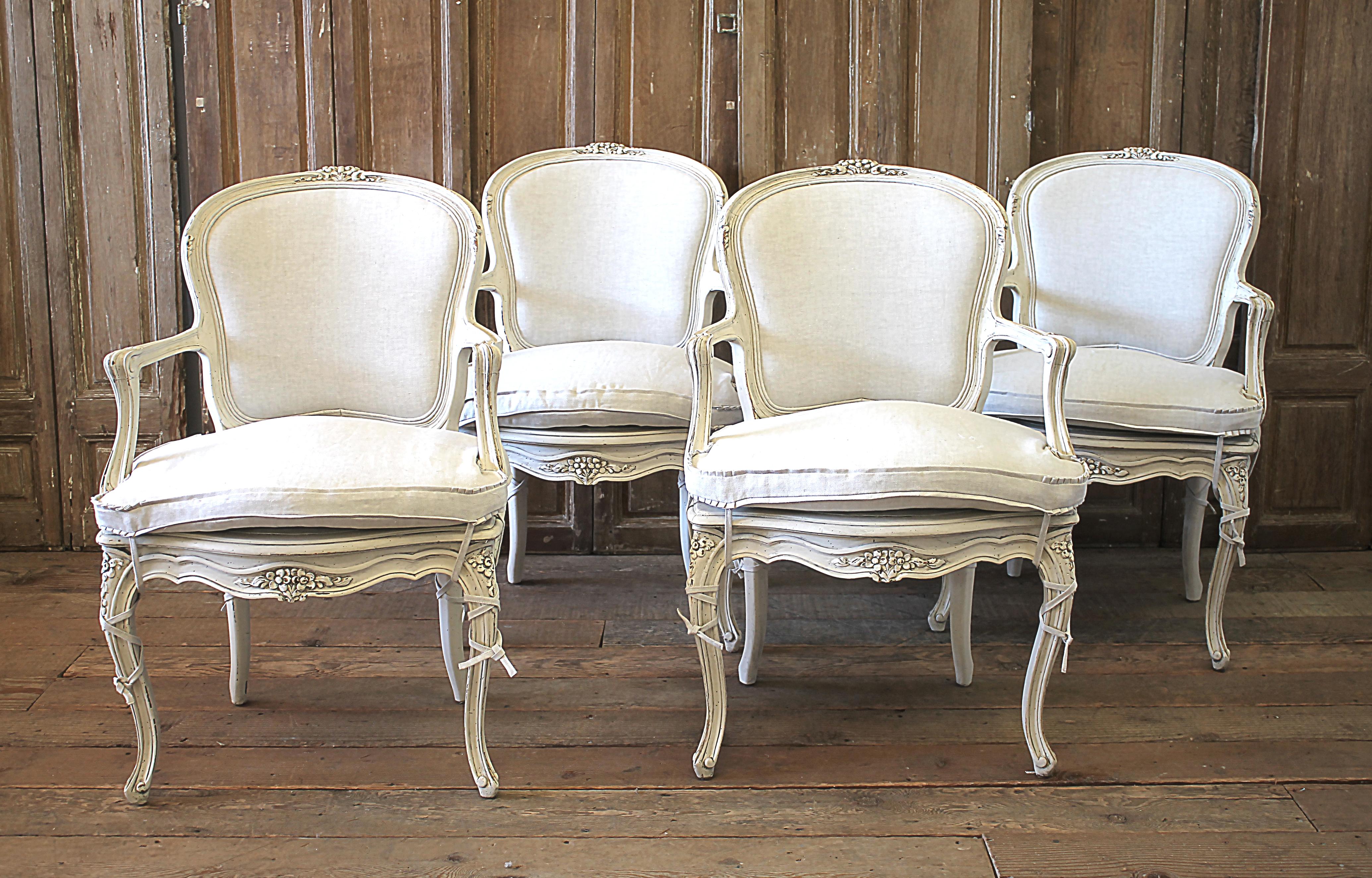 Early 20th century Louis XV style carved and painted open armchairs
Painted in an oyster white finish, with antique patina. The color is an off white, with natural linen upholstery. The natural linen is a greige color, and custom fitted foam