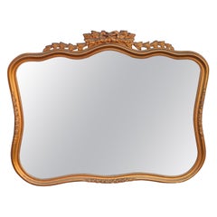 Miroir à cadre en bois doré sculpté de style Louis XV du début du 20e siècle