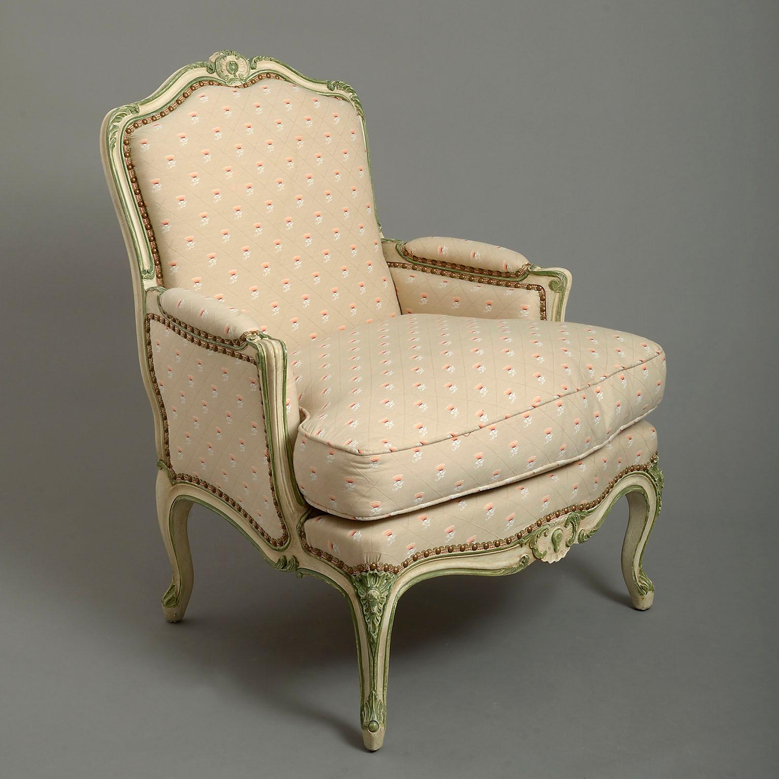 An early 20th century Louis XV style Duchess Brisée, the moulded frame painted green and white, the bergère with loose-cushioned seat and both elements with cabriole legs.