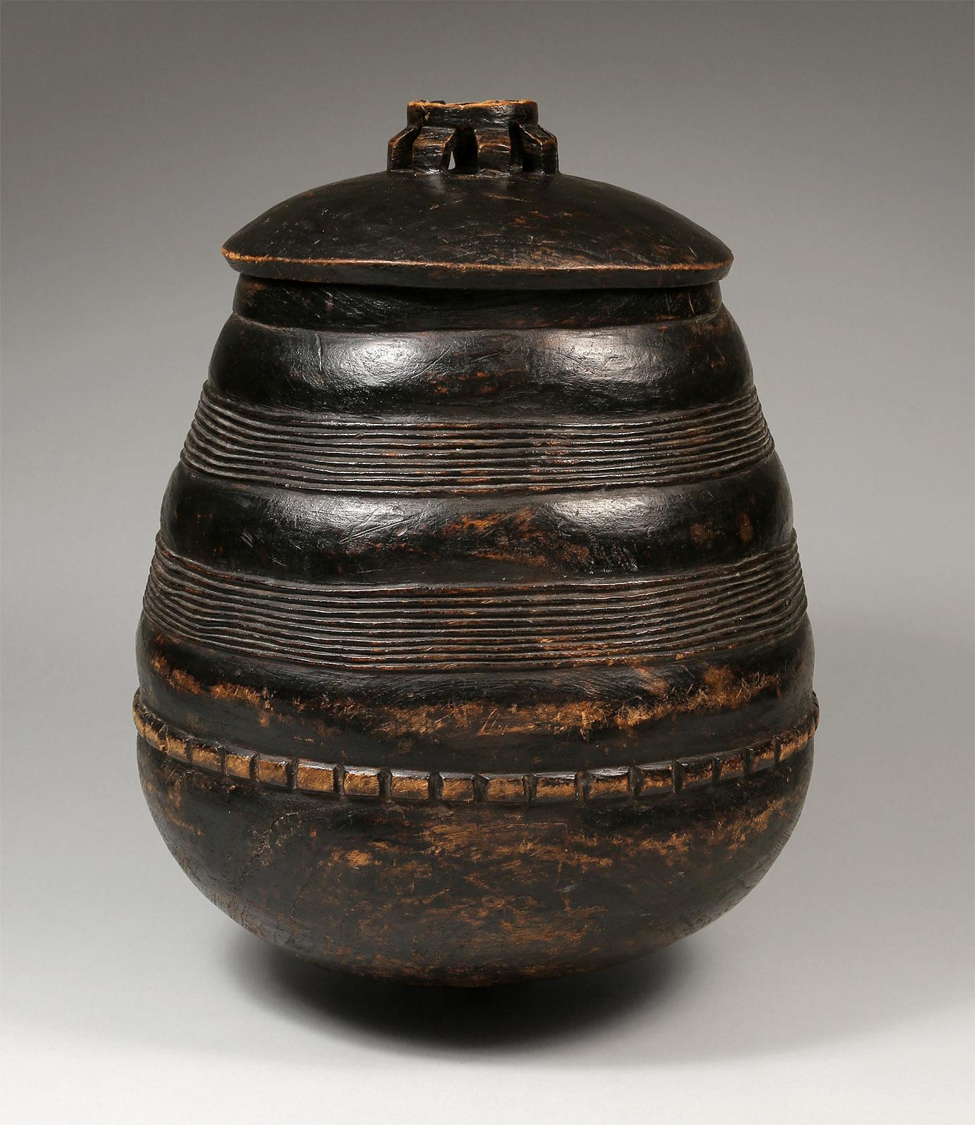 Lozi Wooden Beer Vessel                         
Lozi people, Zambia     
Early 20th century
Carved wood, pigment
H: 16.5 in x W: 11 in x D: 12 in :: 42 cm x 28 cm x 30.5 cm

An elegantly shaped wooden vessel with two rows of incised linear patterns