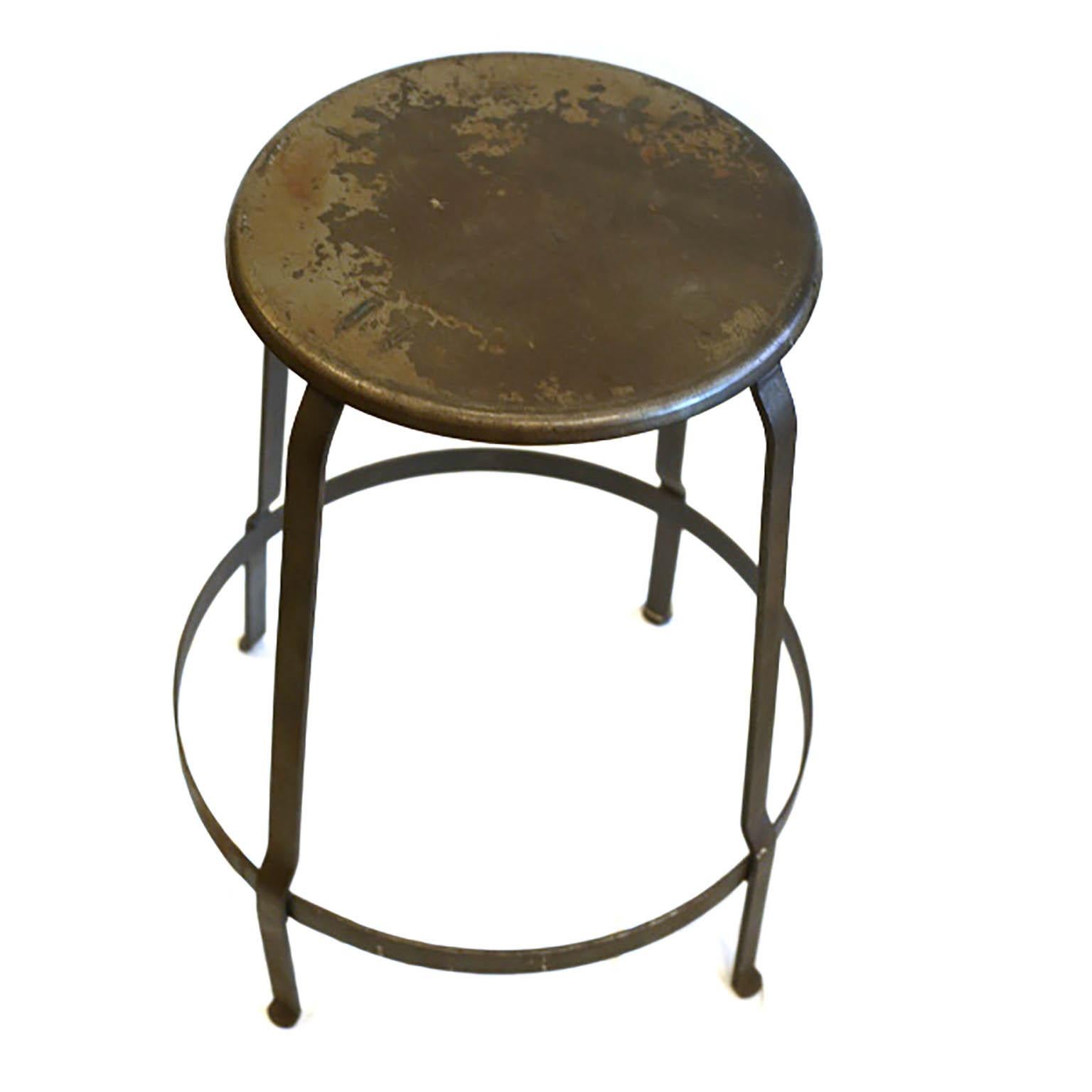 Round steel industrial stool, circa 1930-1940s. Possibly from a factory or machine shop.