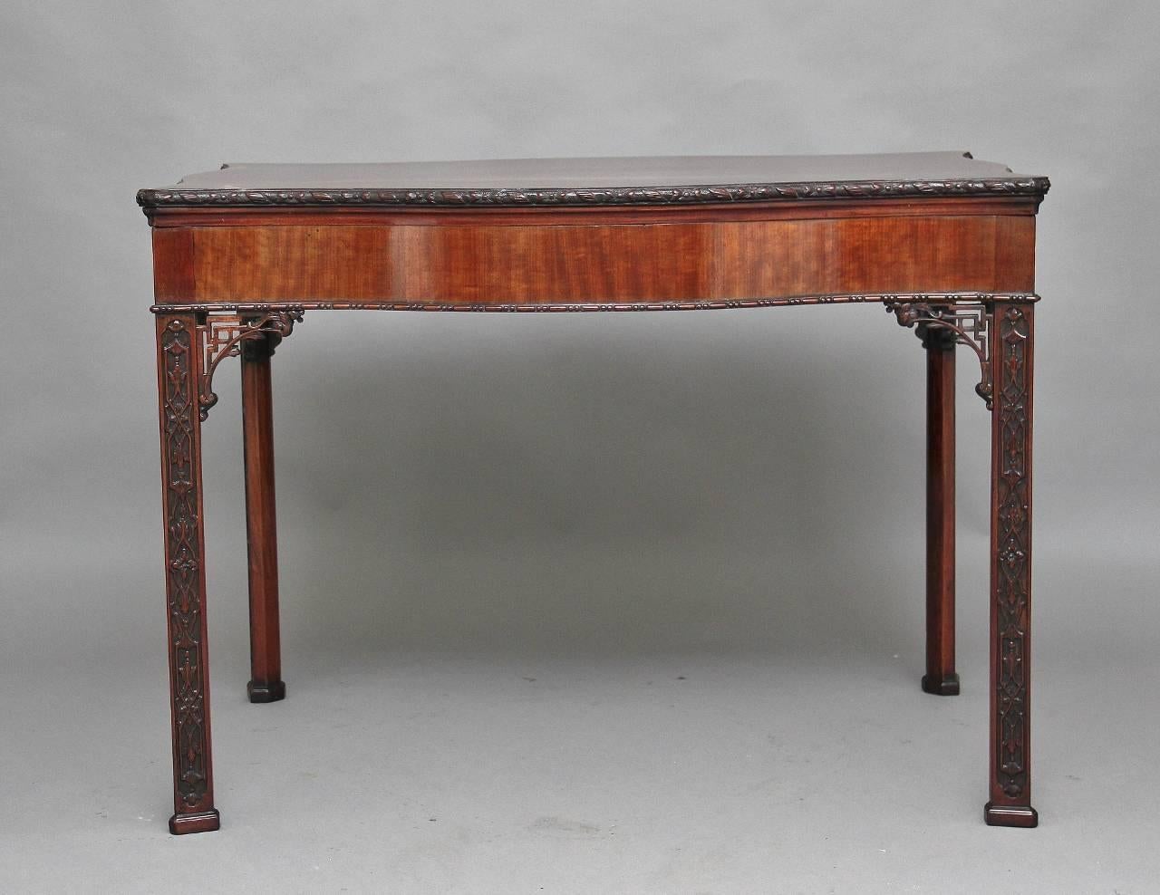 Early 20th century mahogany center table in the Chippendale style of serpentine form, on square legs with blind fret and pierced fret corner brackets terminating with block feet, the lovely colored serpentine top with a mahogany cross band and