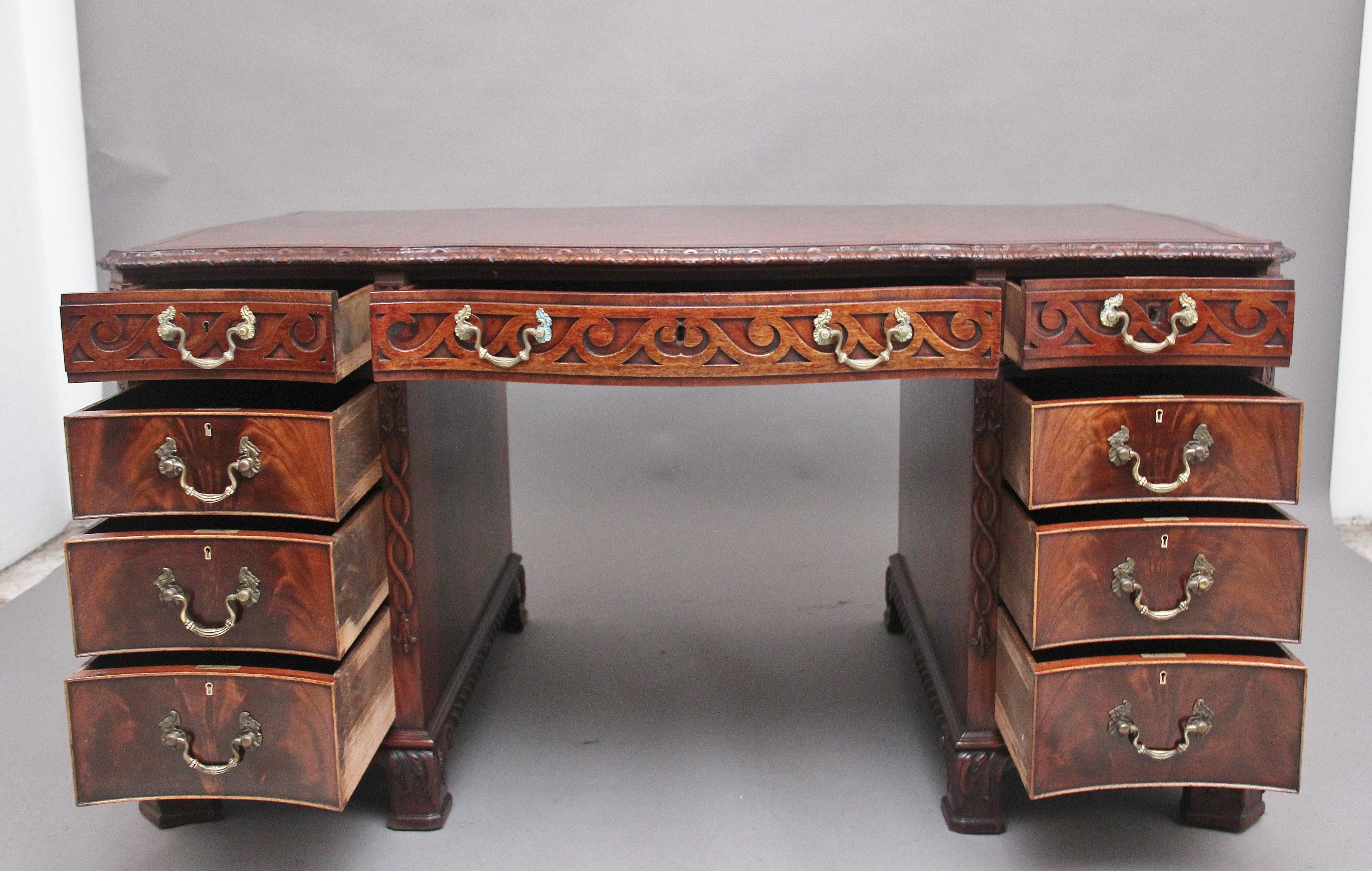Superb quality early 20th Century mahogany pedestal serpentine desk in the Chippendale style, the finely carved moulded edge top having a tobacco coloured leather writing surface decorated with blind tooling, the desk having an arrangement of nine